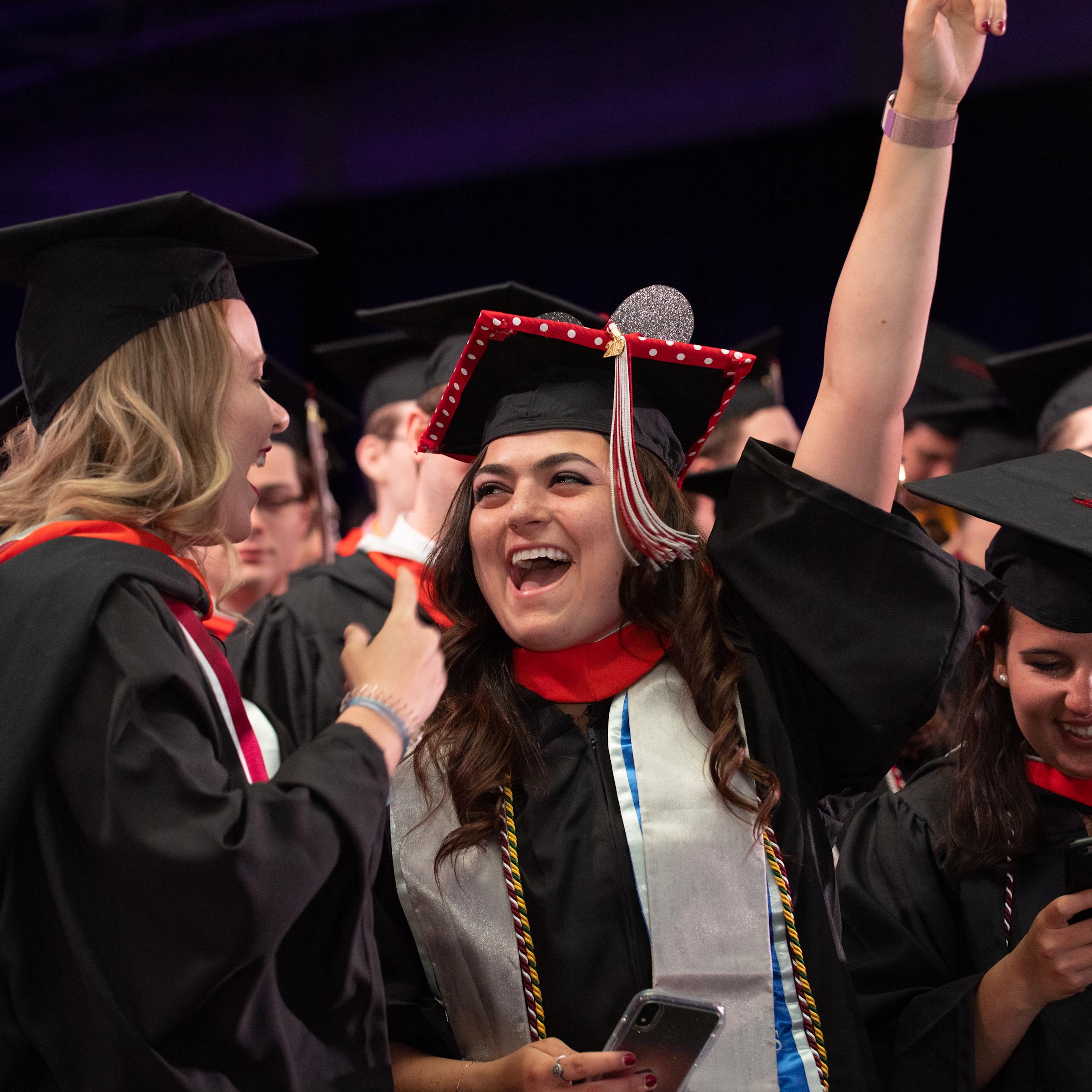 Students celebrate graduation with a big smile.