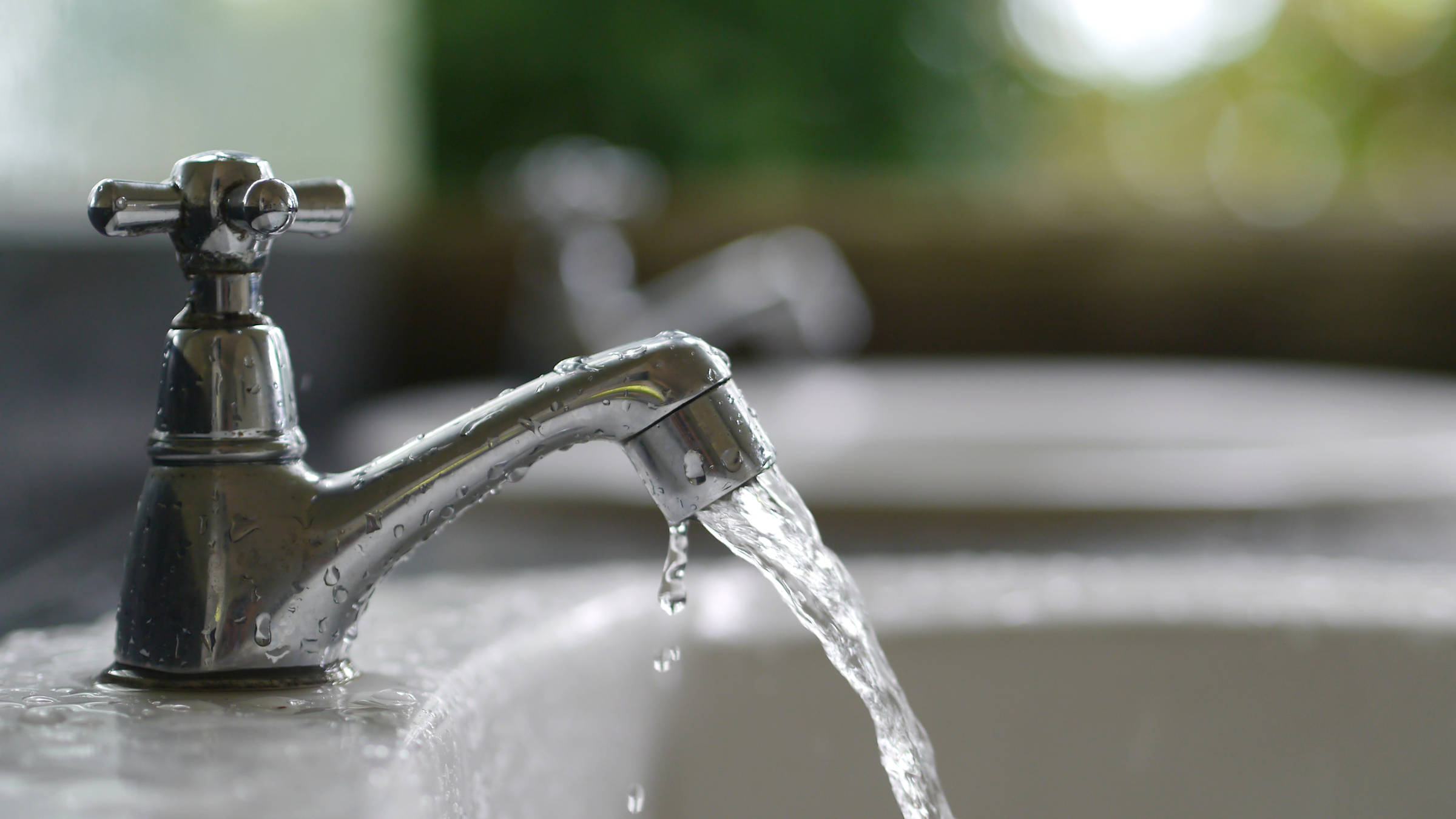 water flowing out of a faucet into a sink