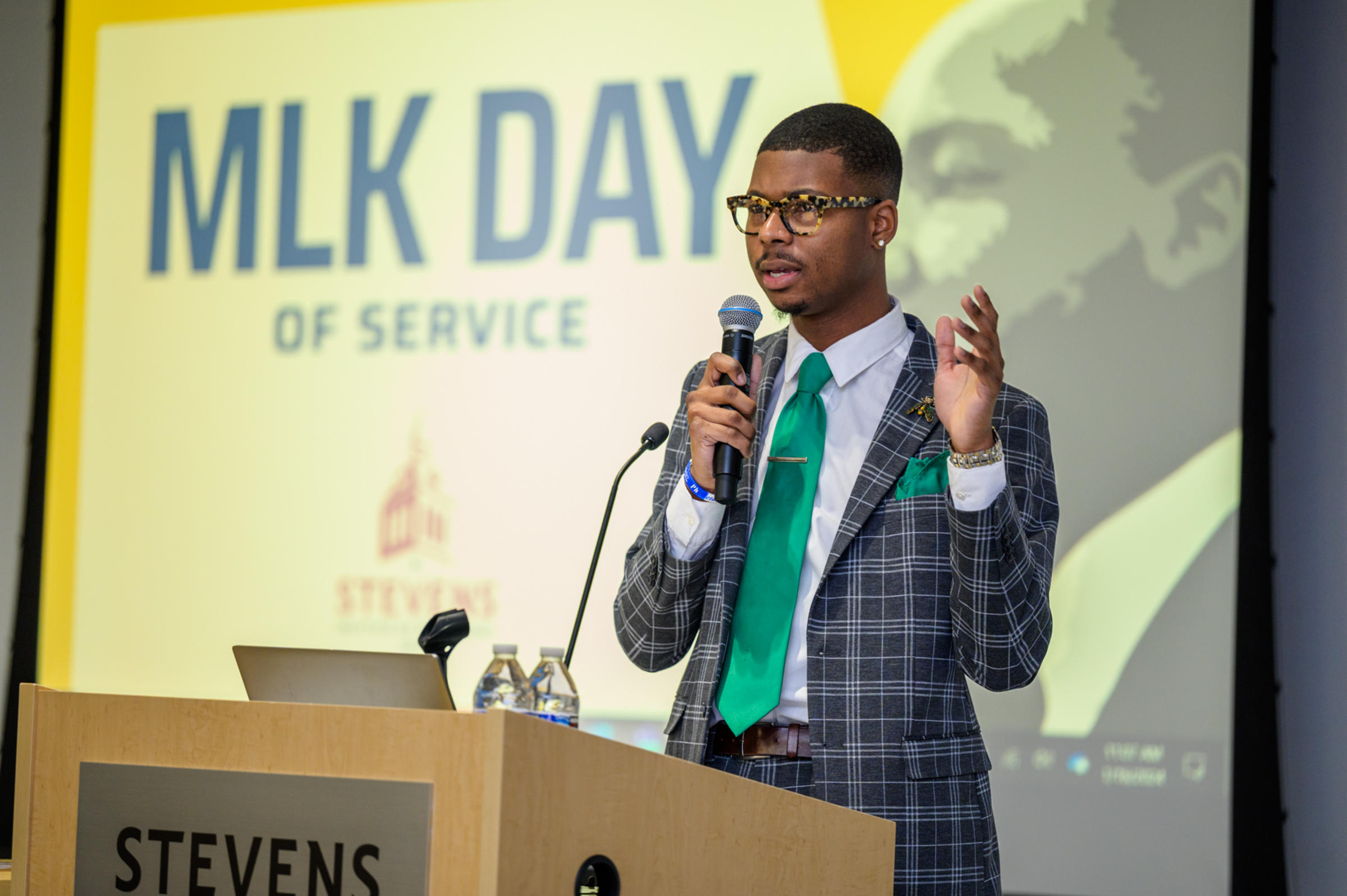 A person standing at a podium speaking into a microphone