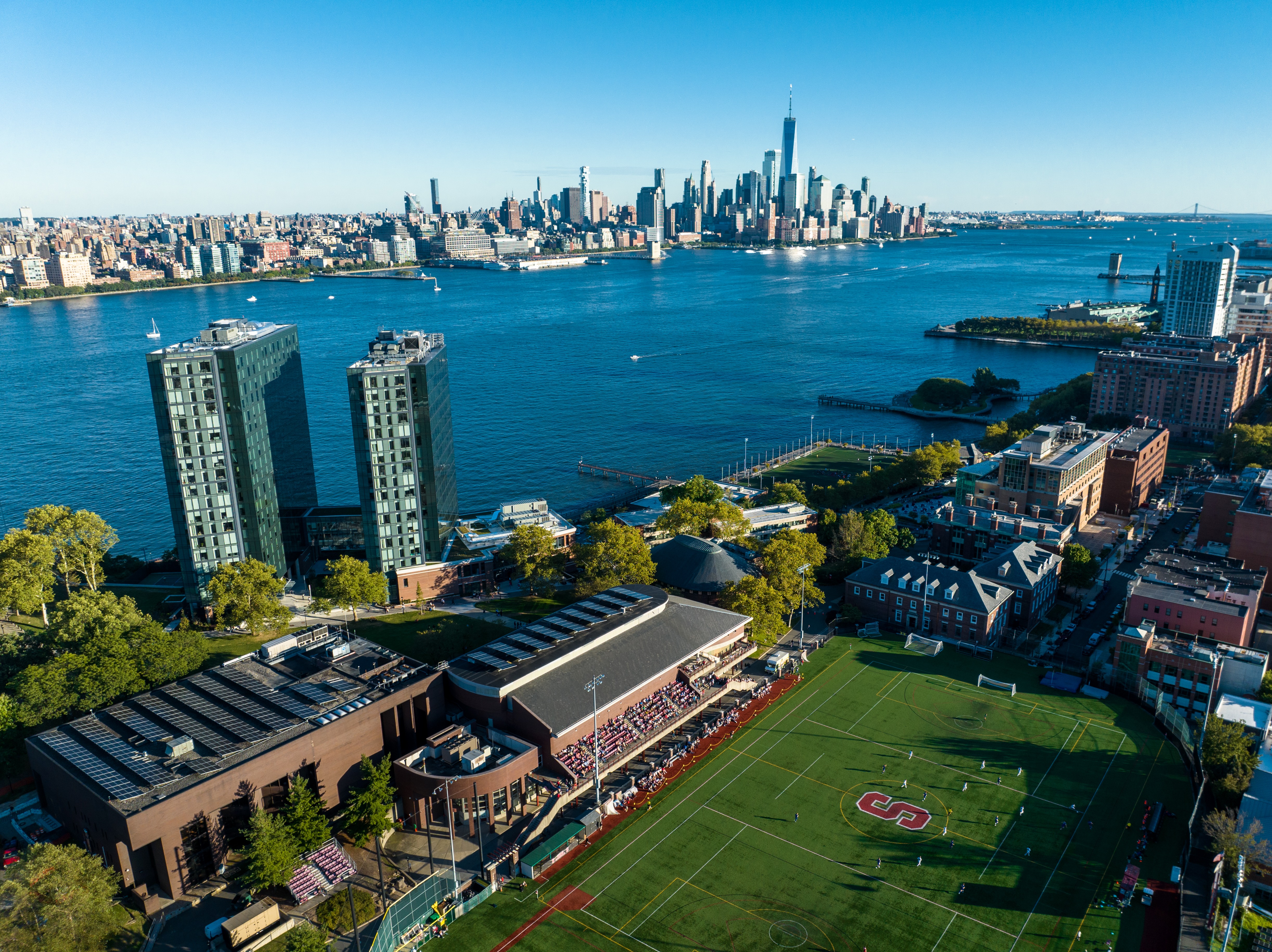 an aerial view of campus, the Hudson River and the NYC skyline
