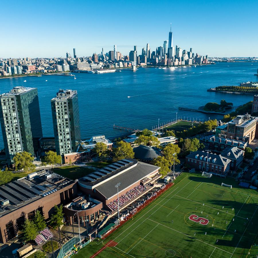 an aerial view of campus, the Hudson River and the NYC skyline