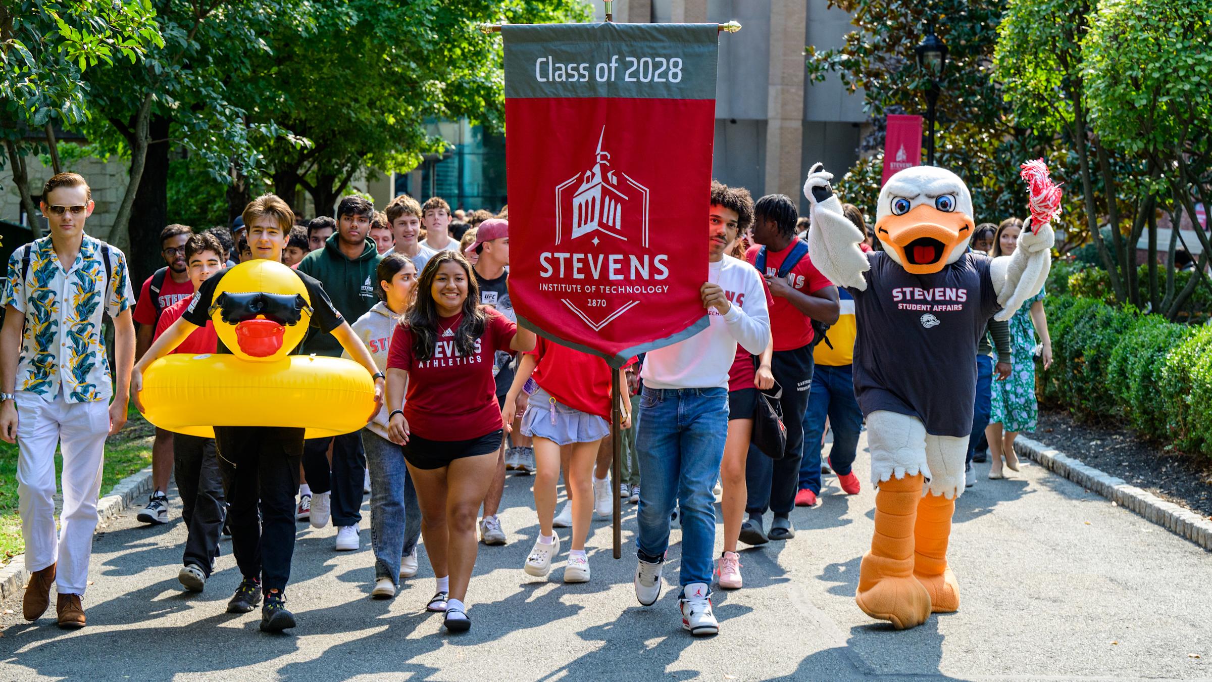 The incoming Class of 2028 with banner and Attilla at Wittpenn Walk