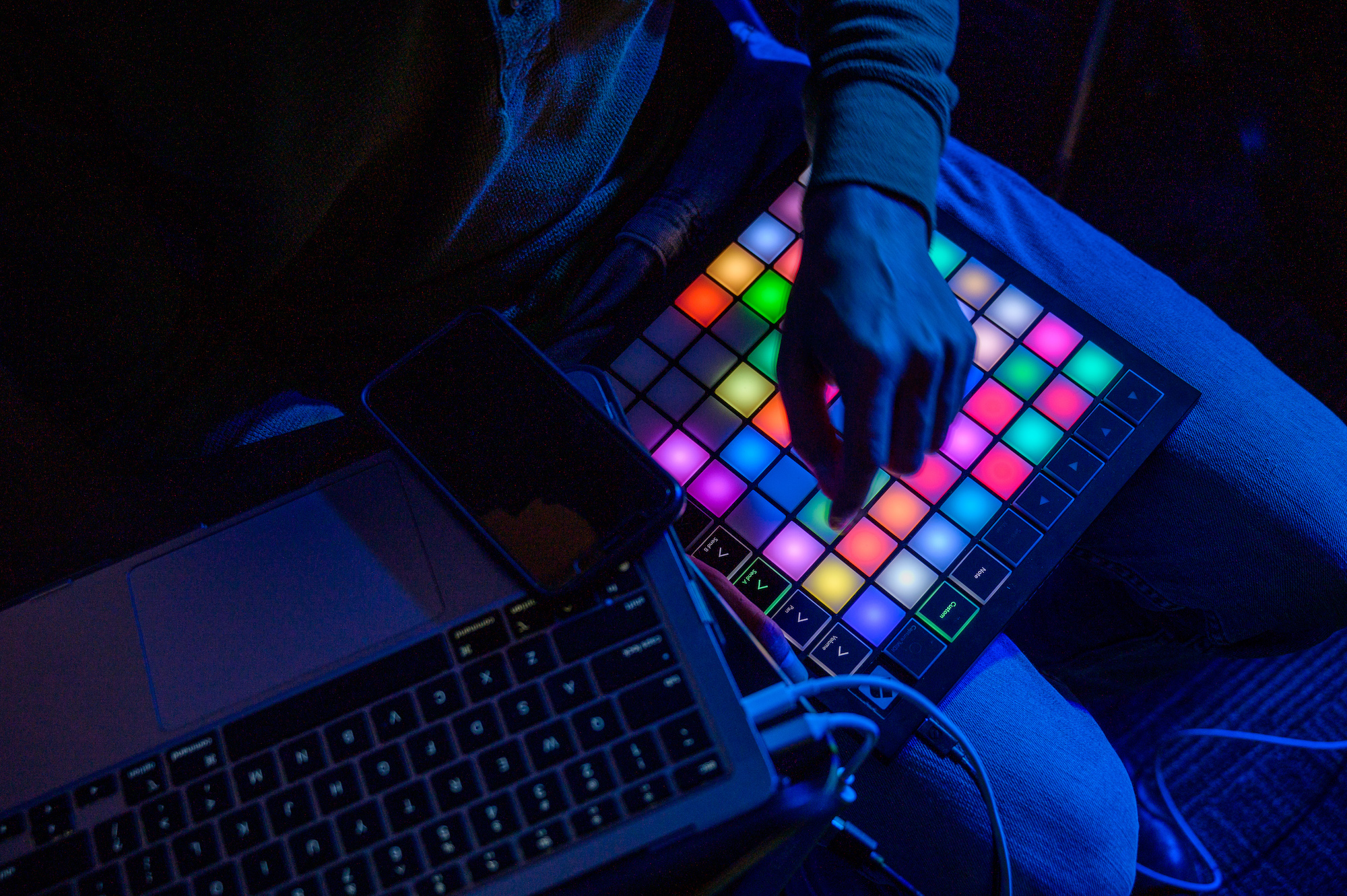 Three students look at a mosaic at the visual arts and technology senior exhibition