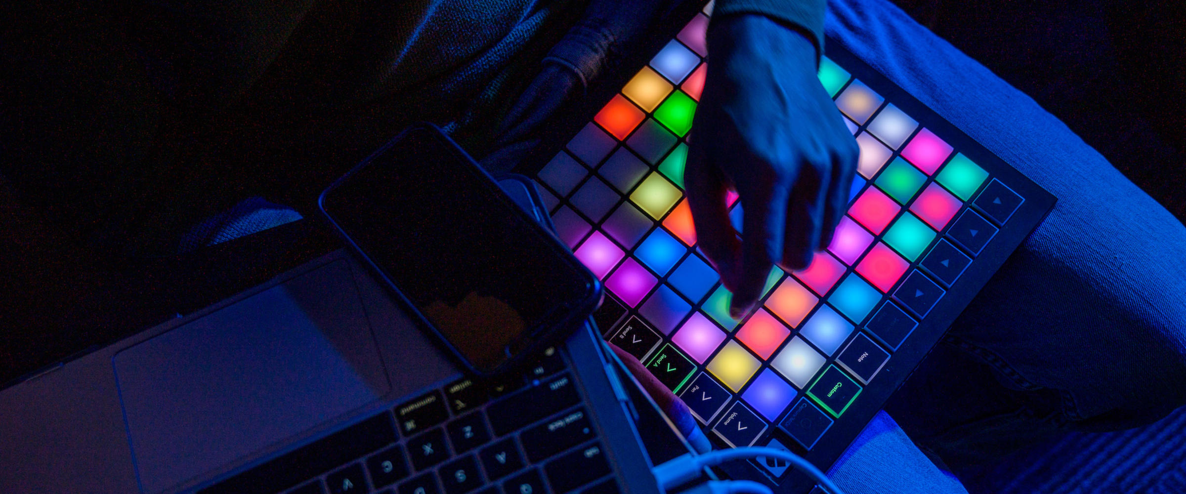 Three students look at a mosaic at the visual arts and technology senior exhibition