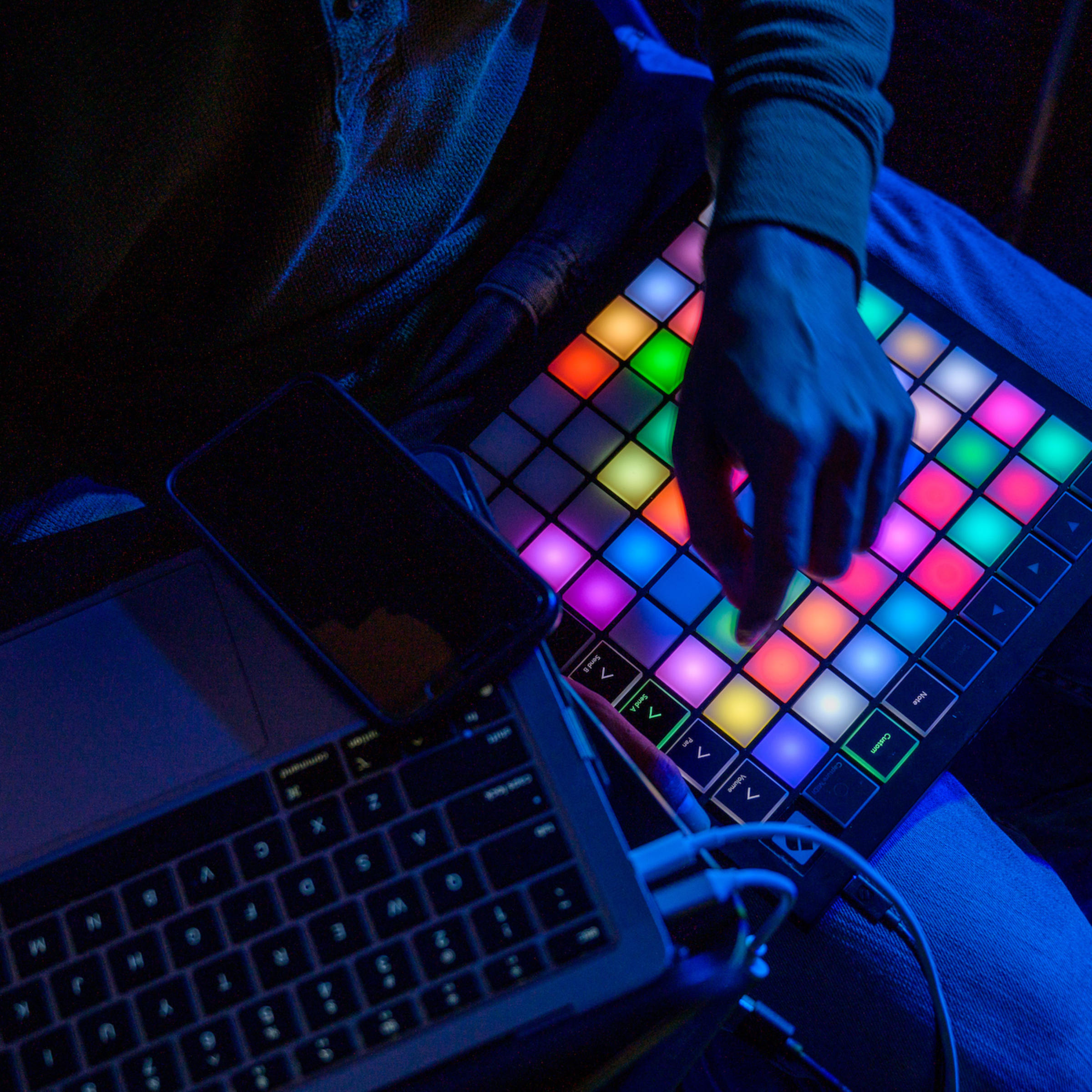 Three students look at a mosaic at the visual arts and technology senior exhibition