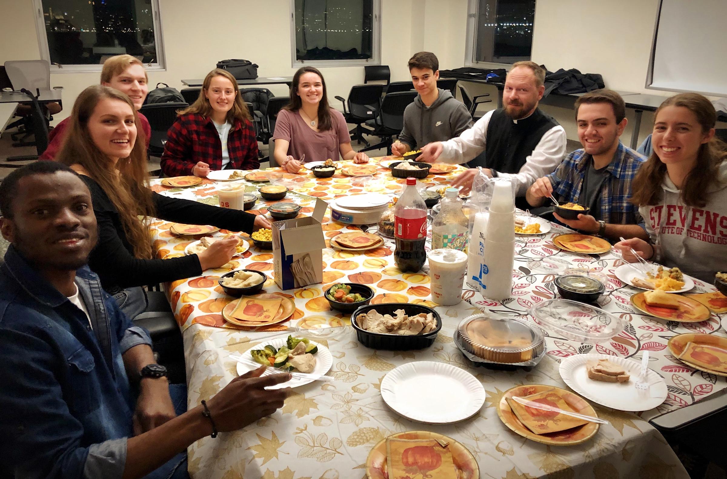Members of students eating together at a table