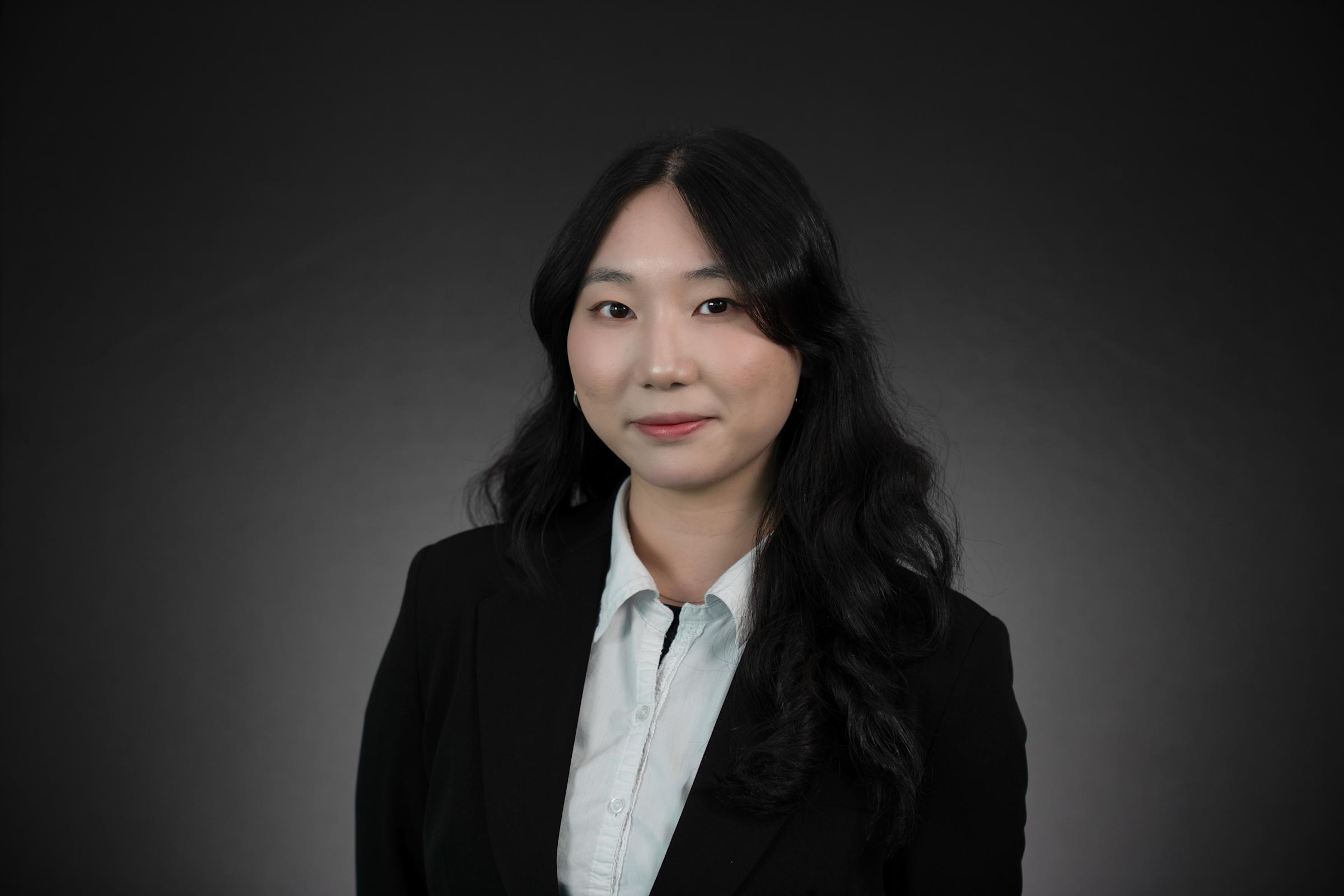 Headshot of Fiona Shi wearing professional attire.