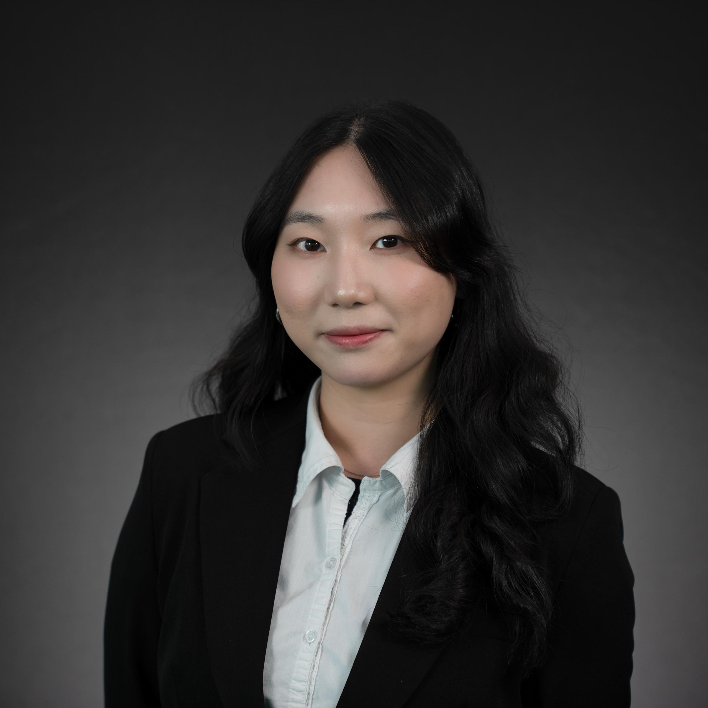 Headshot of Fiona Shi wearing professional attire.