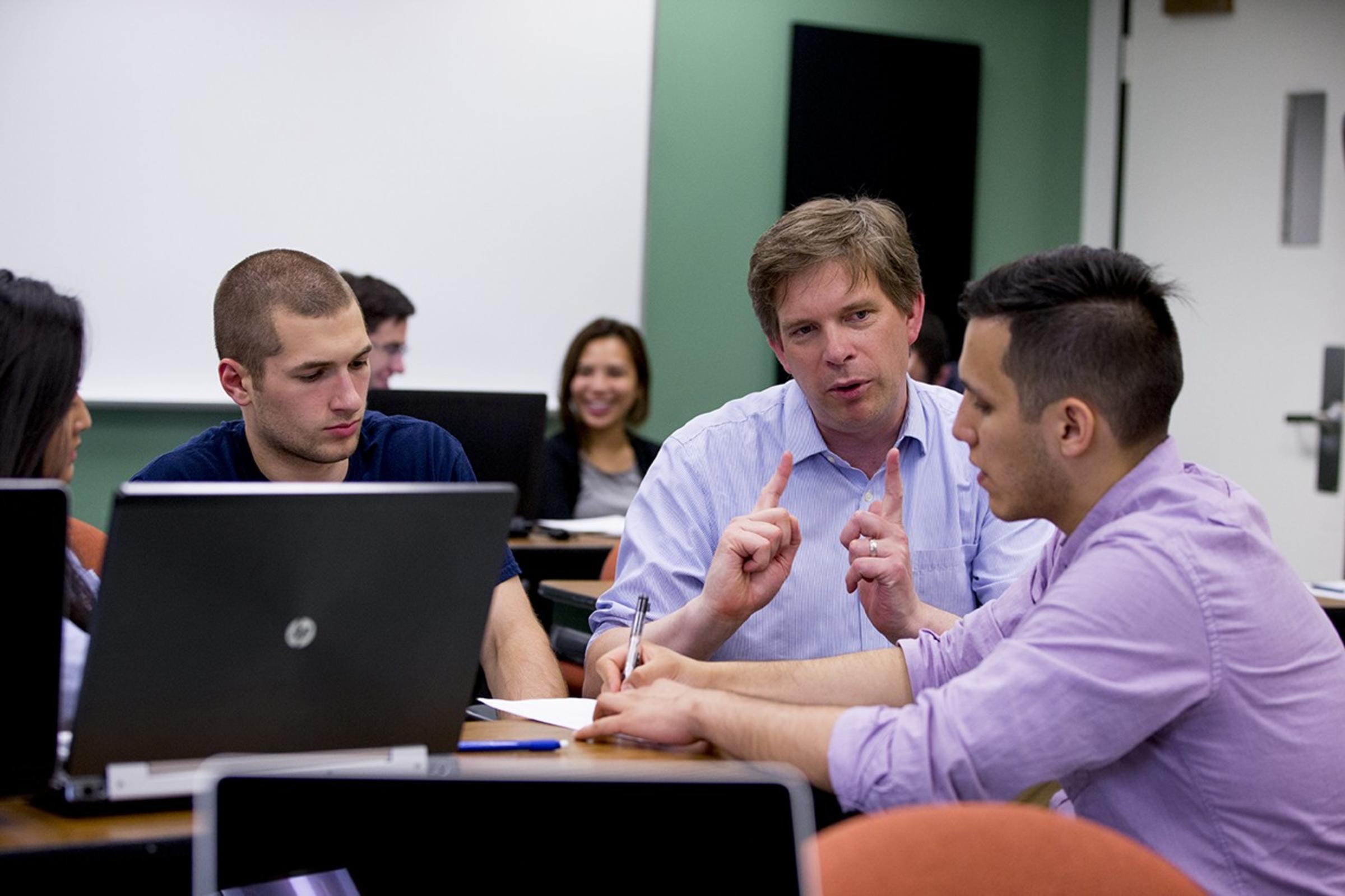 Male students and Professor in classroom