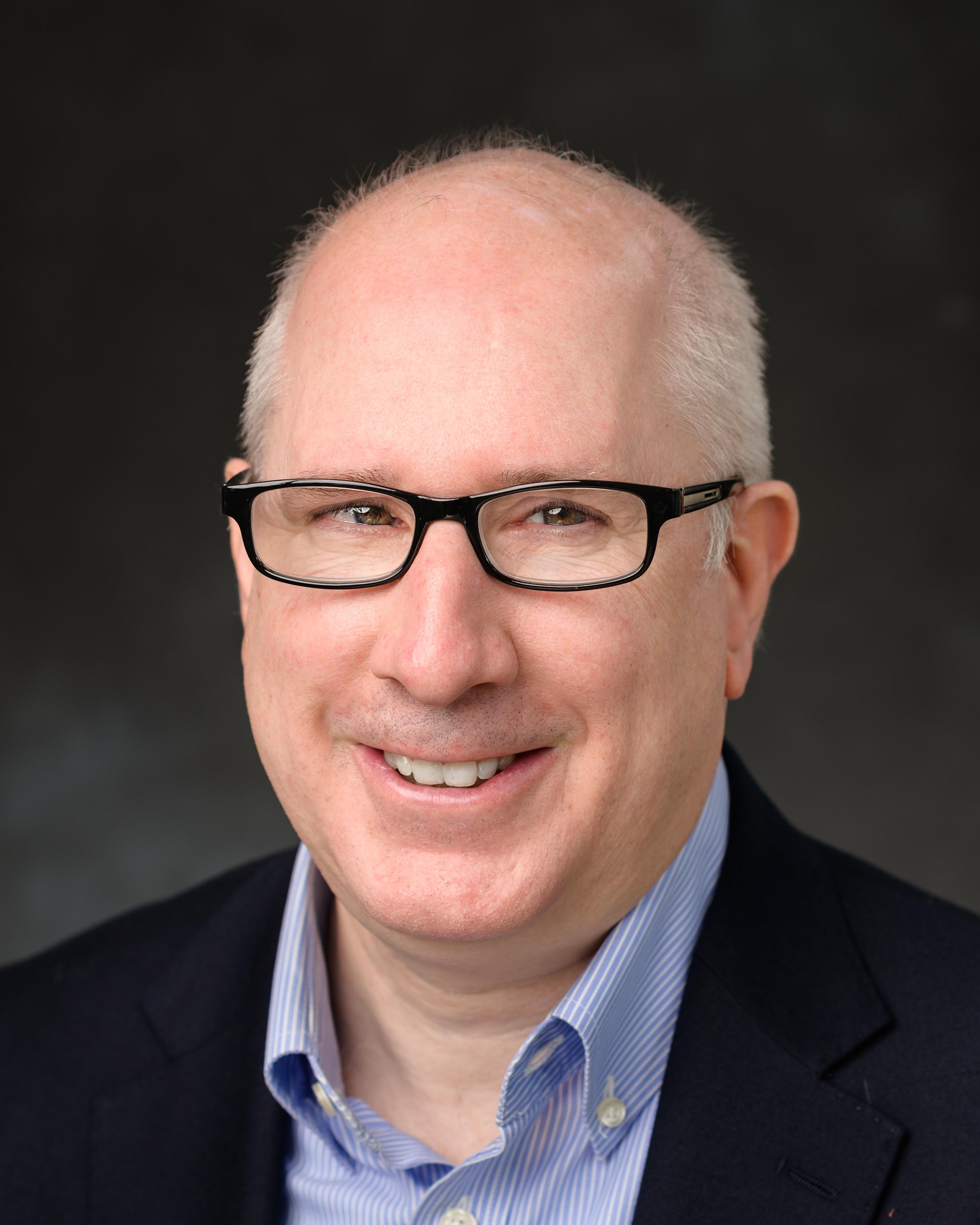 A headshot of Michael Hofmann, our Senior Brand and Graphics Manager