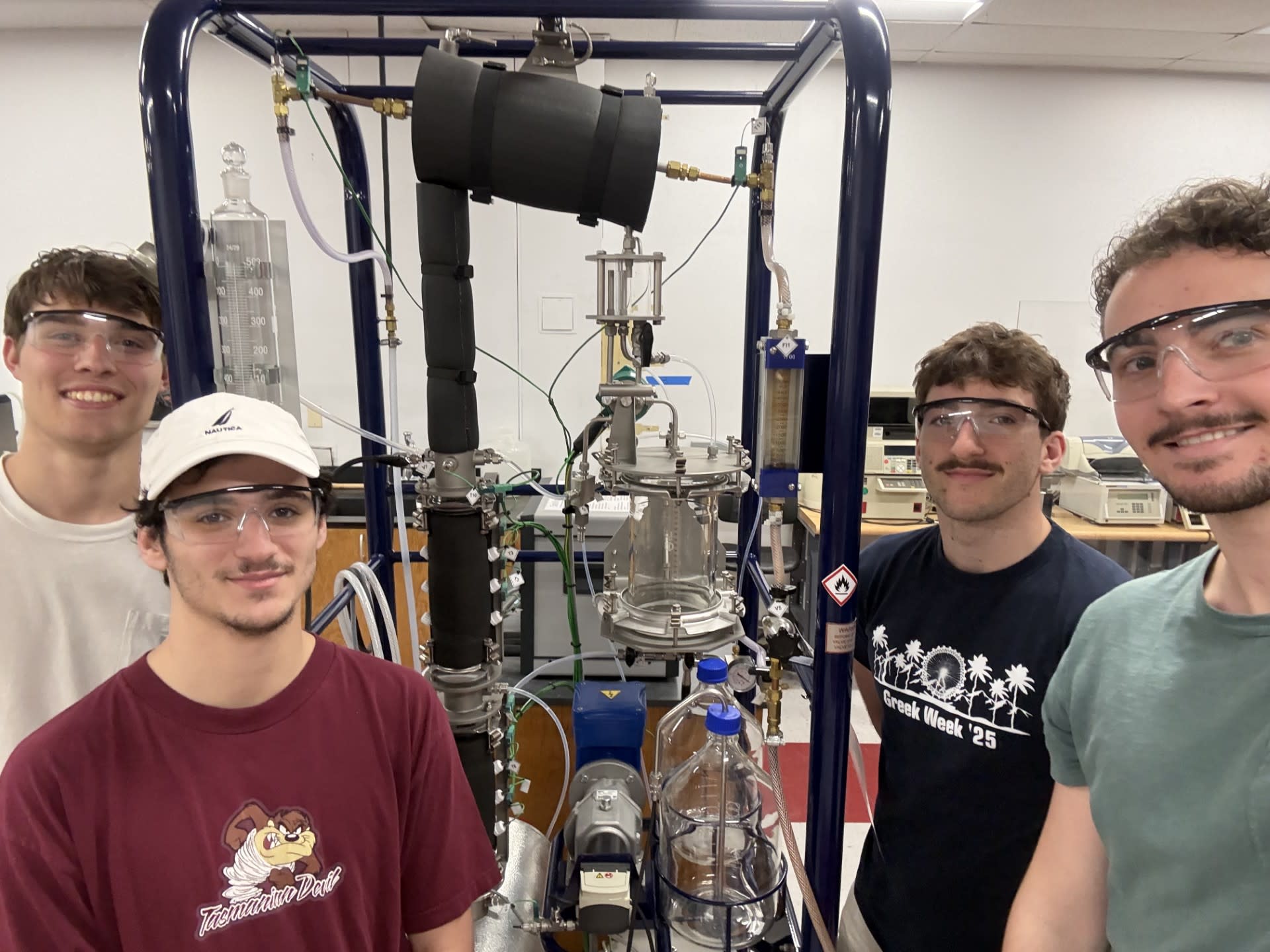Students Dean Wise, Max Adler, Ty Vallorosi and David Riedell pose in a lab with their prototype. 