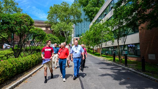 Student guide and alumni walk down the Wittpenn walk.