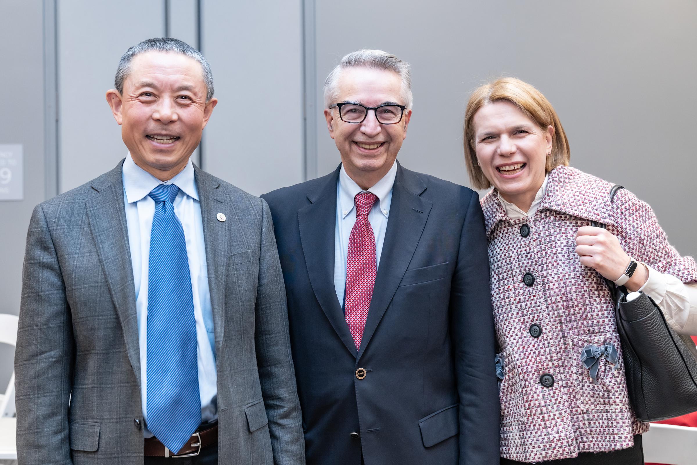 Gregory Prastacos stand between Jianmin Qu and his wife, Olympia.