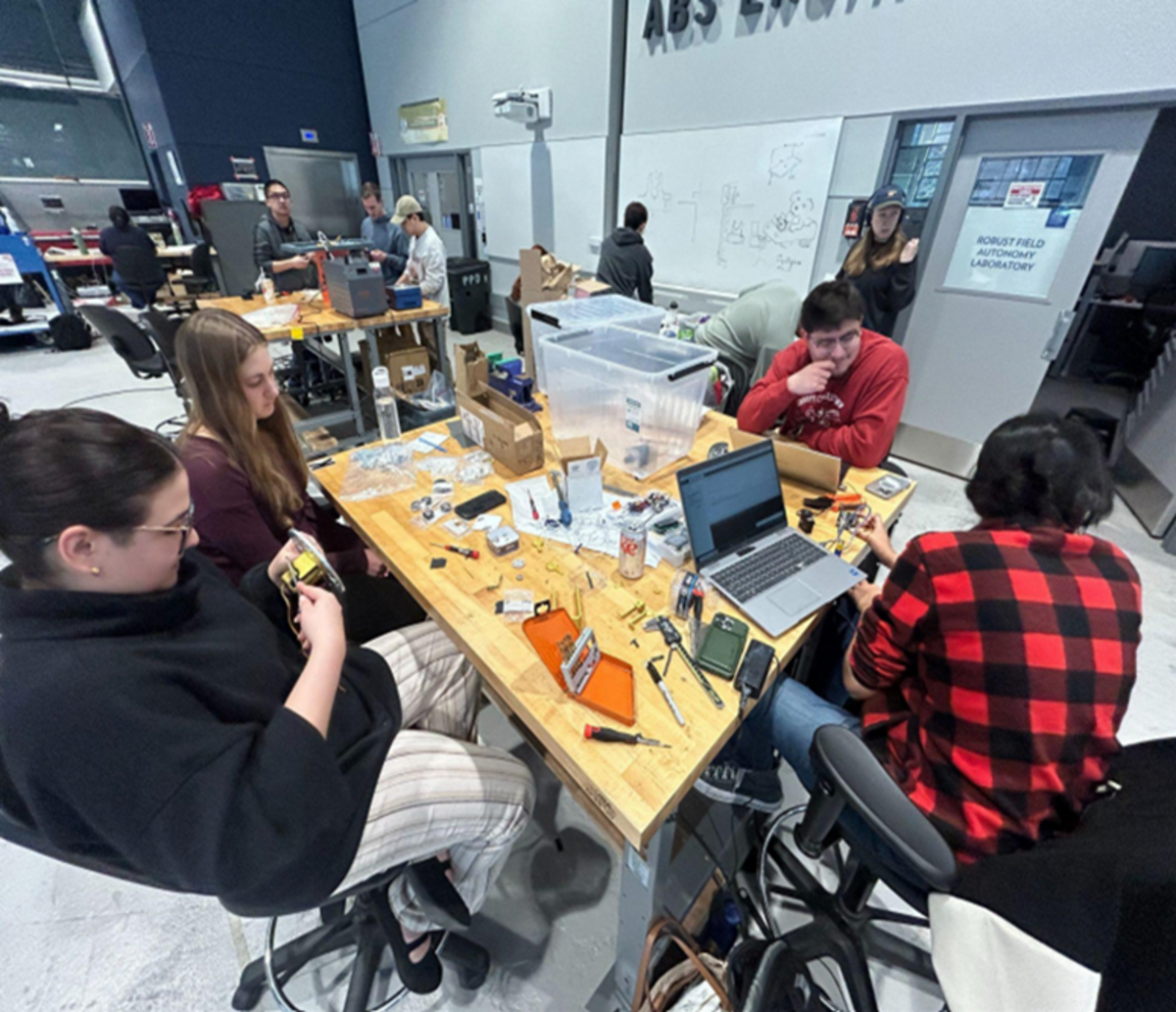 Working on the prototype and conducting motor testing are (from left) Catherine Stabile, Ekaterini Koukoulis, Jonathan Solorzano and Manavi Panjnani.