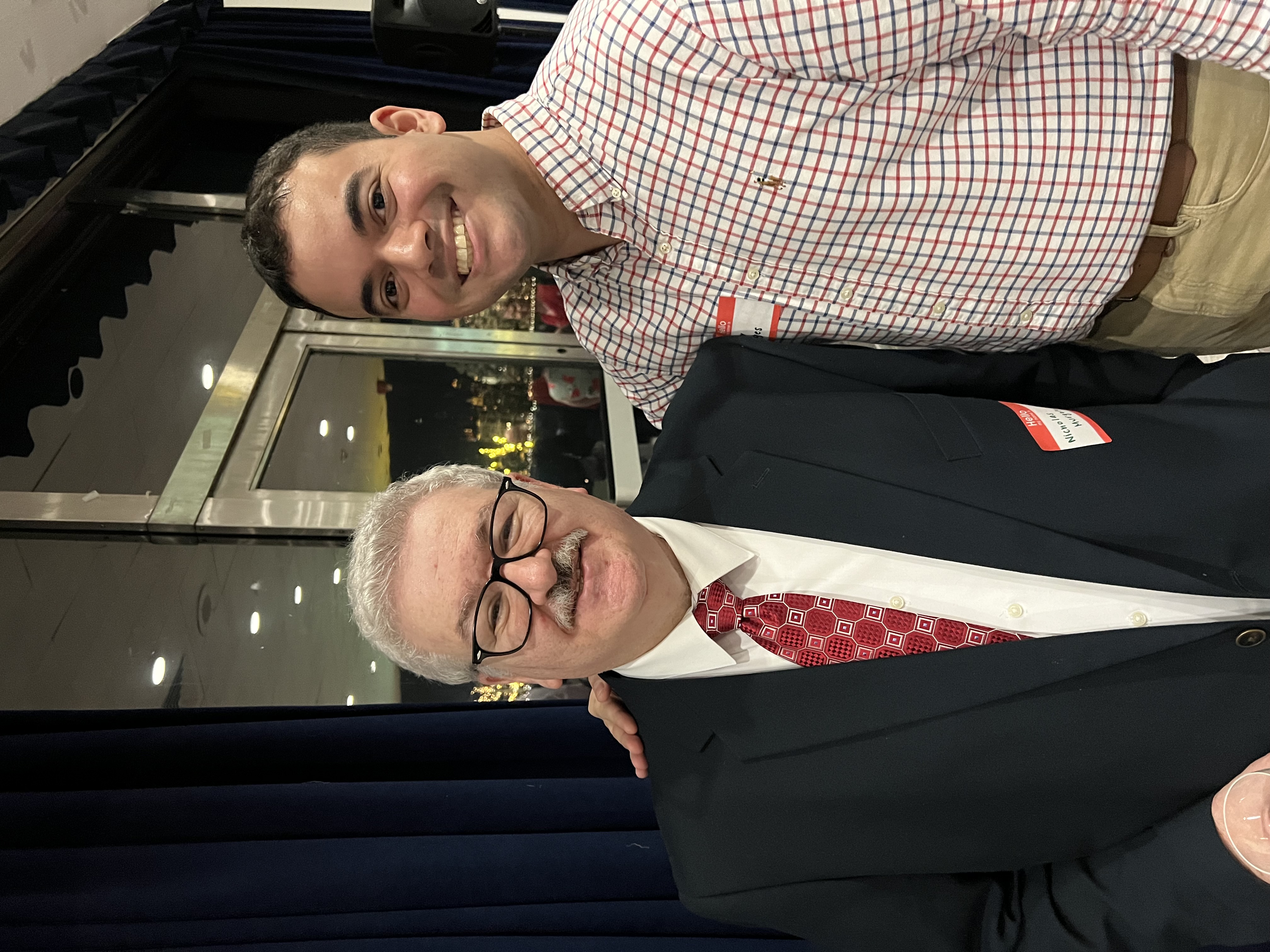 Hector Borges stands next to Nick Murgulo, with his arm around his shoulders