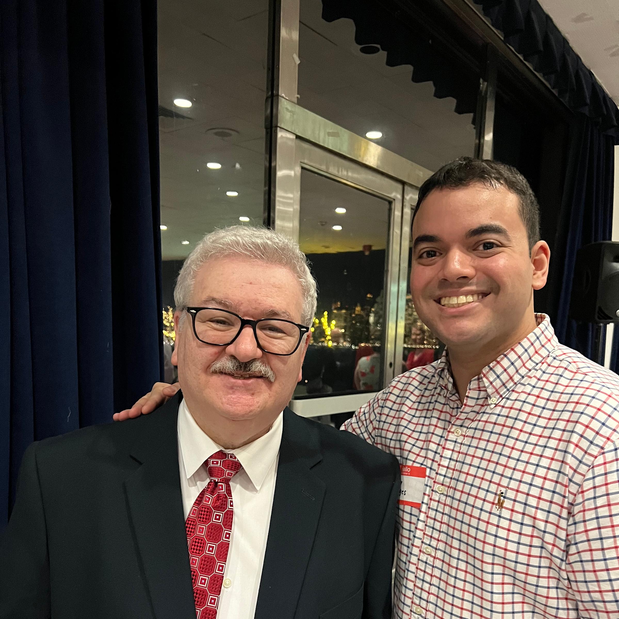 Hector Borges stands next to Nick Murgulo, with his arm around his shoulders