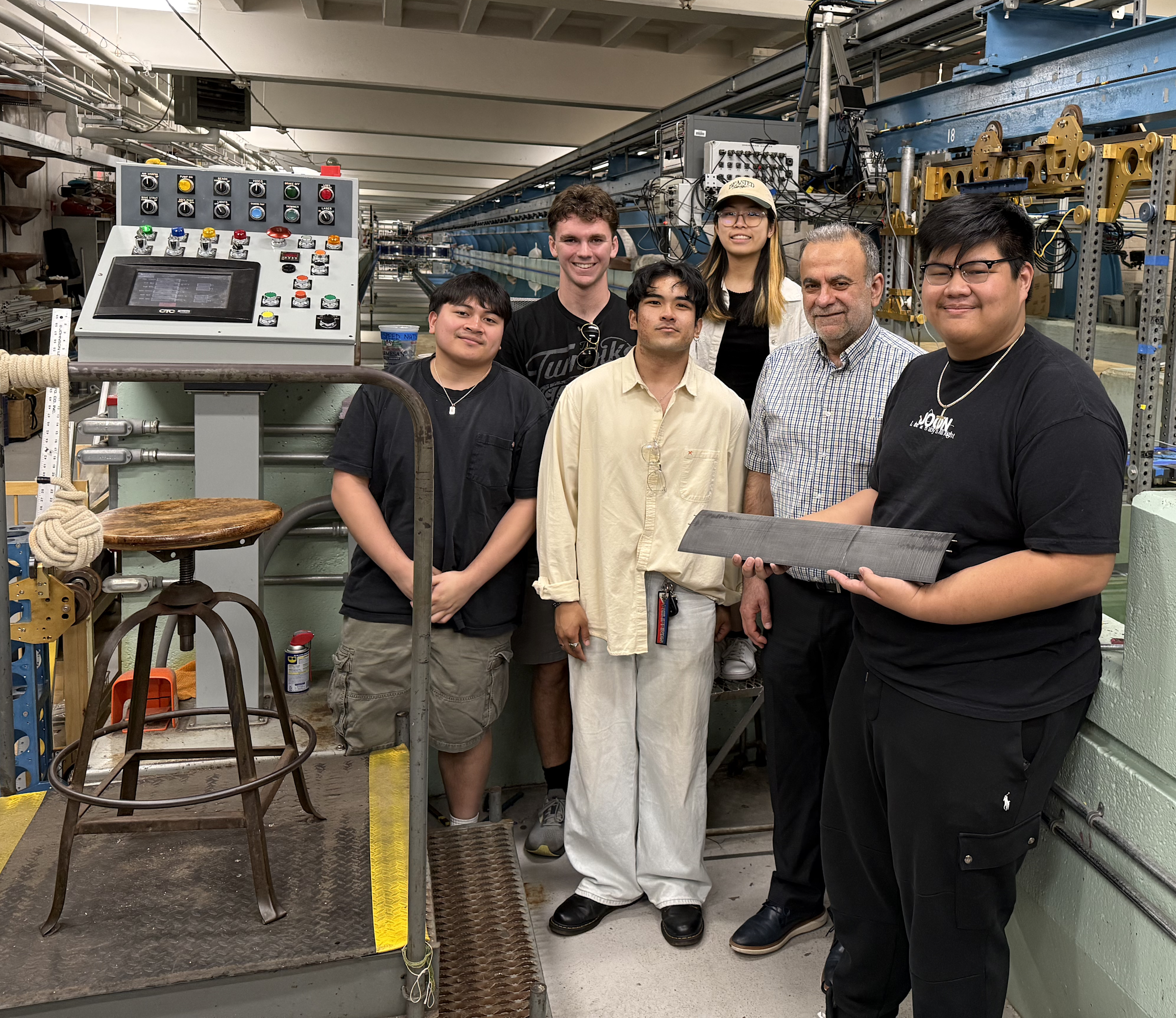  Benedict Martinez, Andrew Vallent, Jess Irvin Peleo, Alyson Zhang, faculty advisor Muhammad Hajj and John Figueras stand with their work in the Davidson Lab.