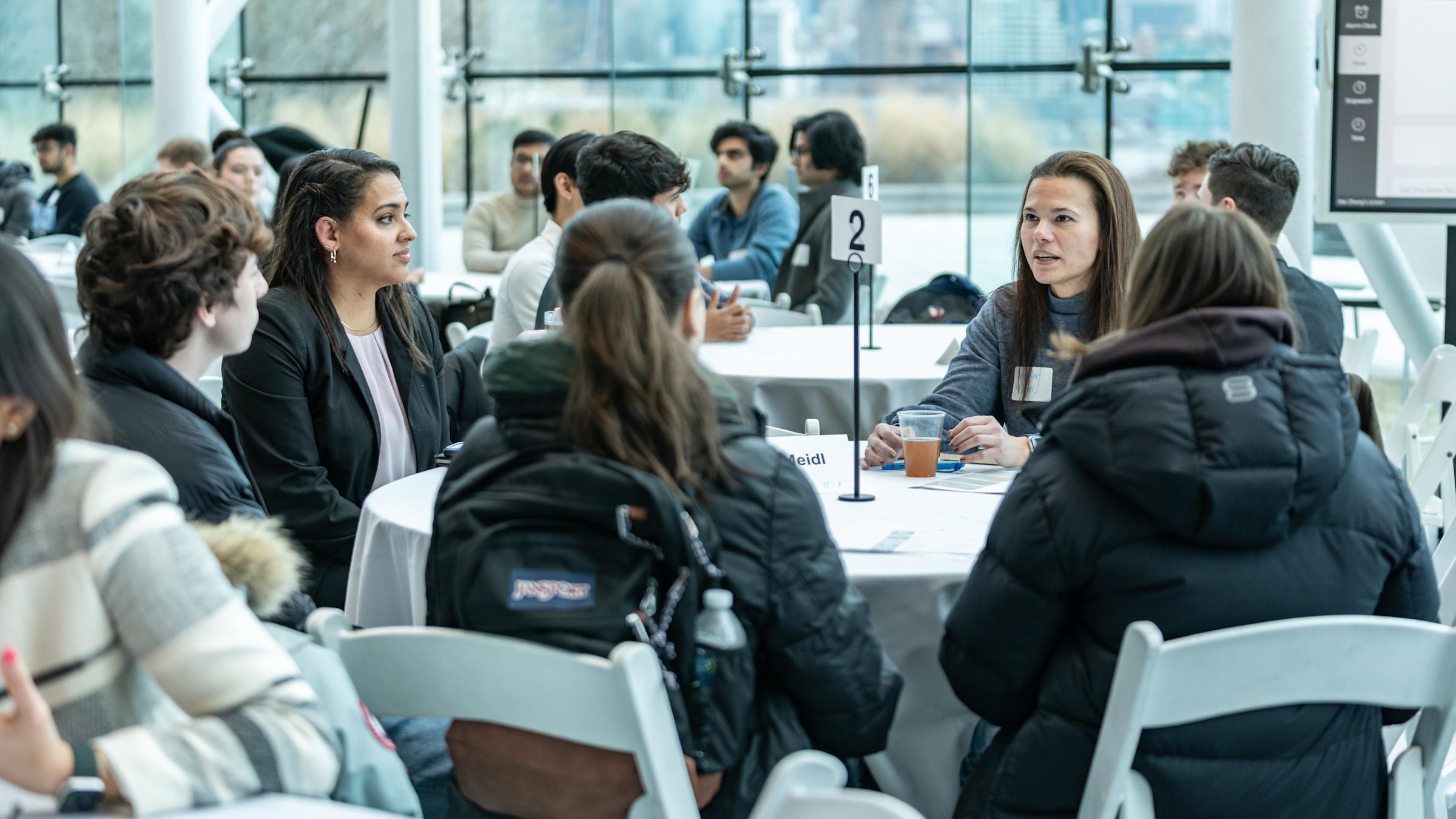 Group of participants engage with a Stevens alumnus