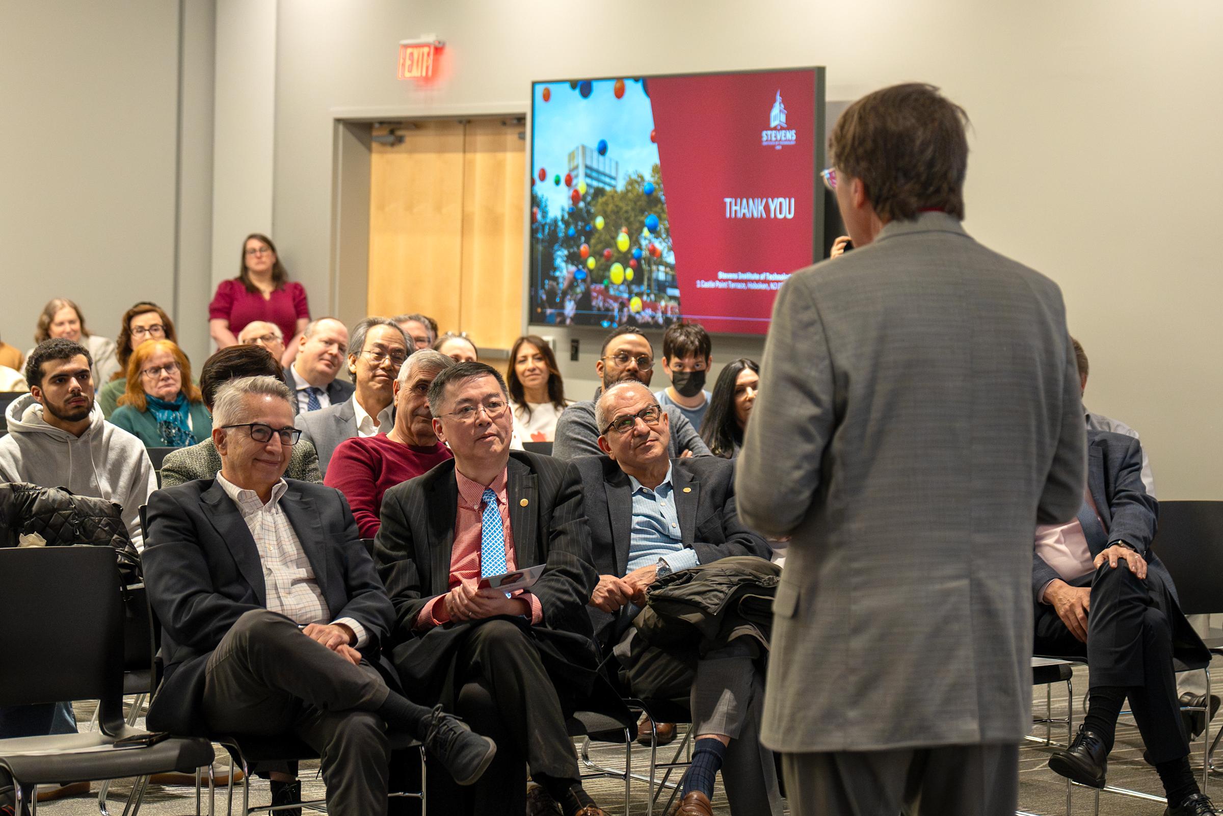 Kevin Ryan faces the audience with Dean Gregory Prastacos and Stevens President Nariman Farvardin in the front row.