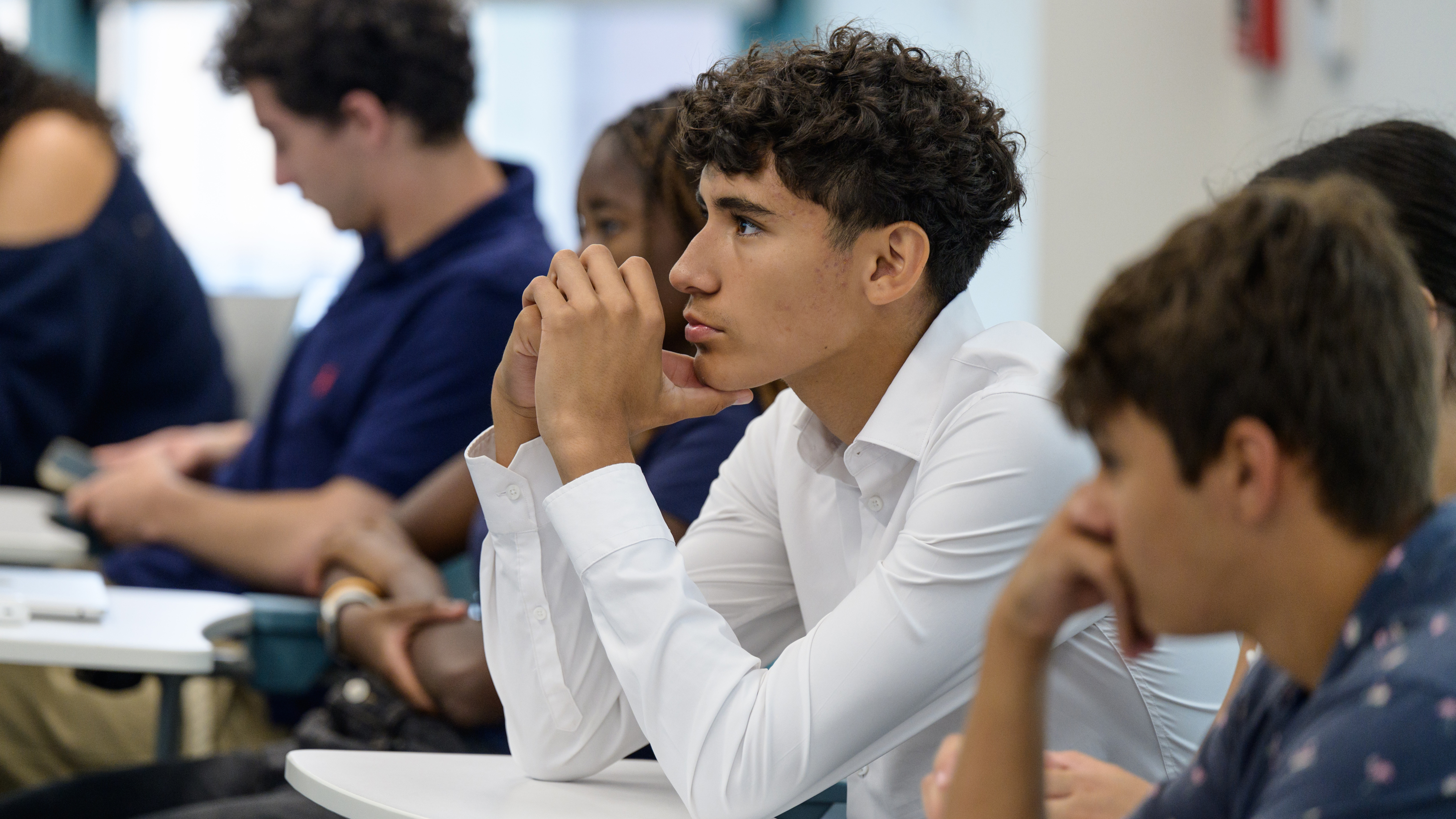 Student listening attentively during a classroom discussion.