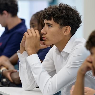 Student listening attentively during a classroom discussion.