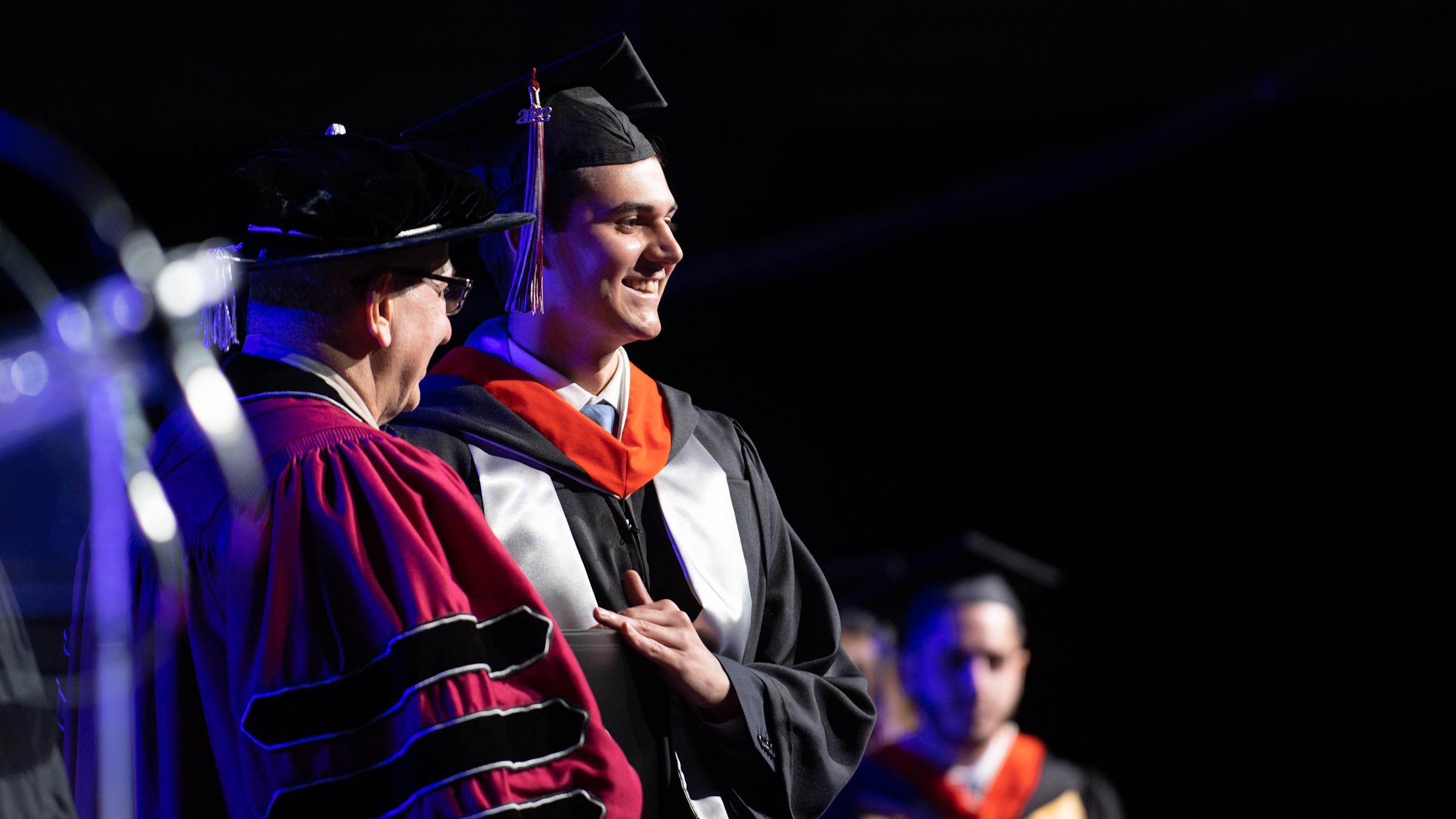 A student received his diploma from Stevens President Nariman Farvardin at the 2022 Undergraduate Commencement Ceremony.