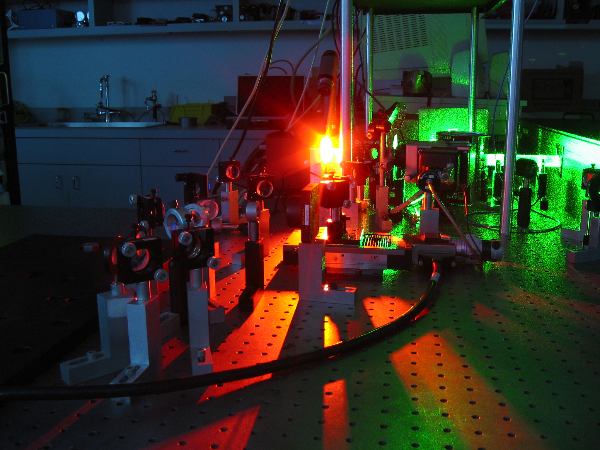 A front facing laser emanating from equipment in a lab.