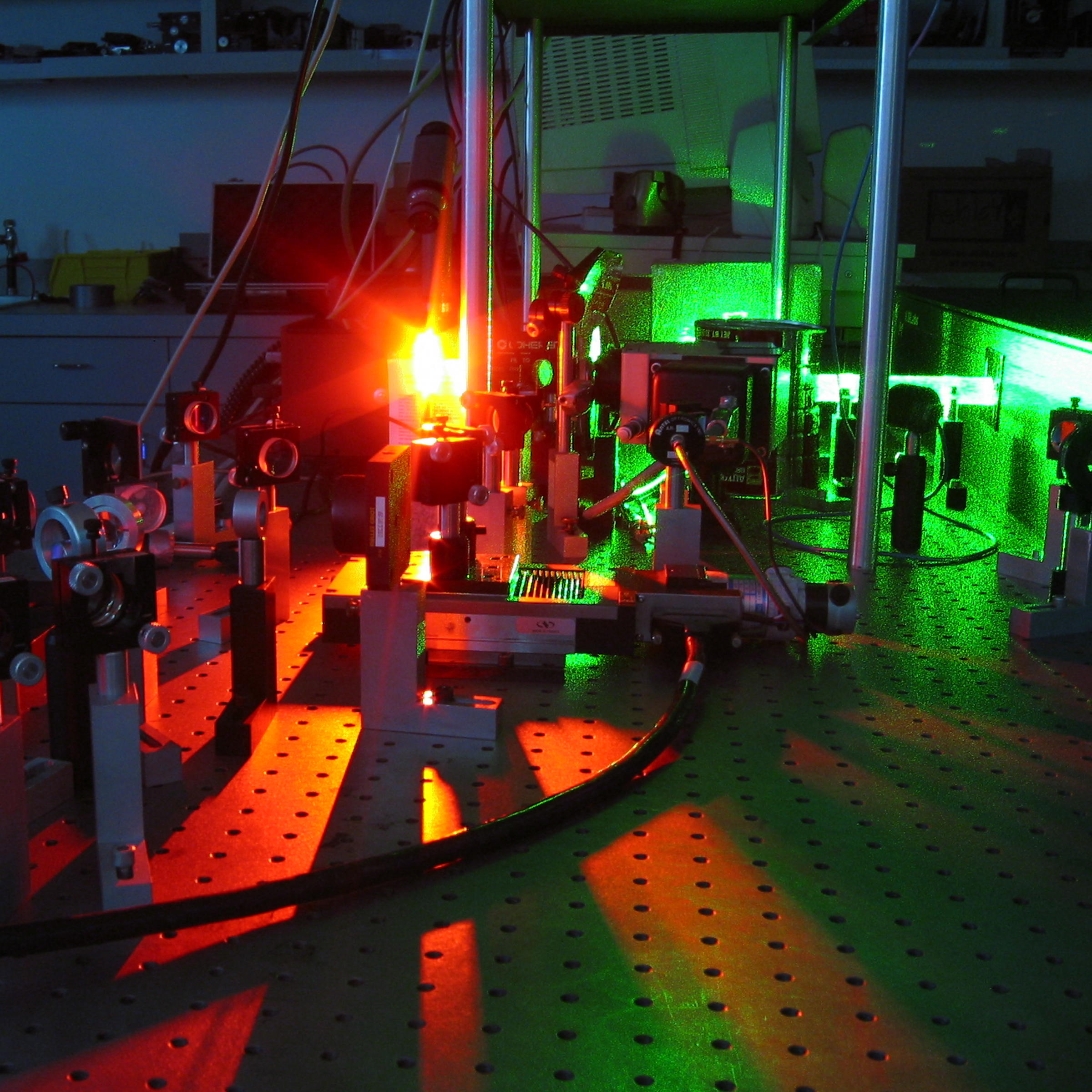 A front facing laser emanating from equipment in a lab.