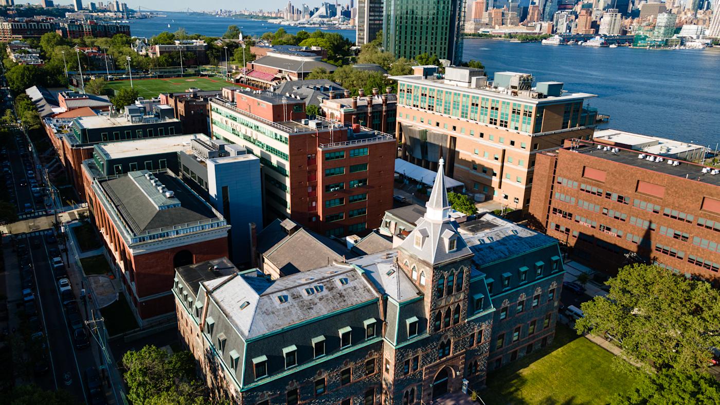 An aerial image of the Stevens campus across the Hudson River from Manhattan.