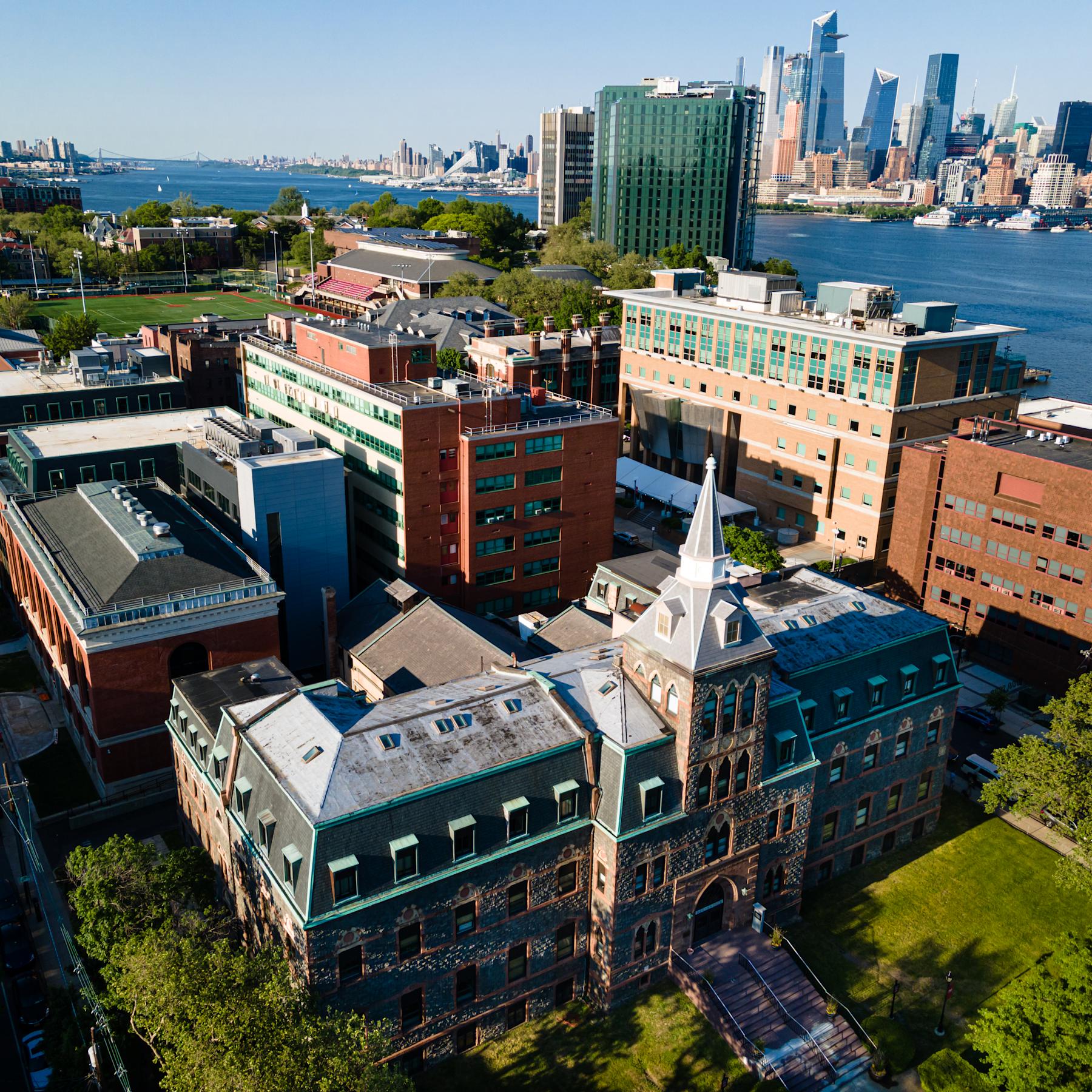 An aerial image of the Stevens campus across the Hudson River from Manhattan.