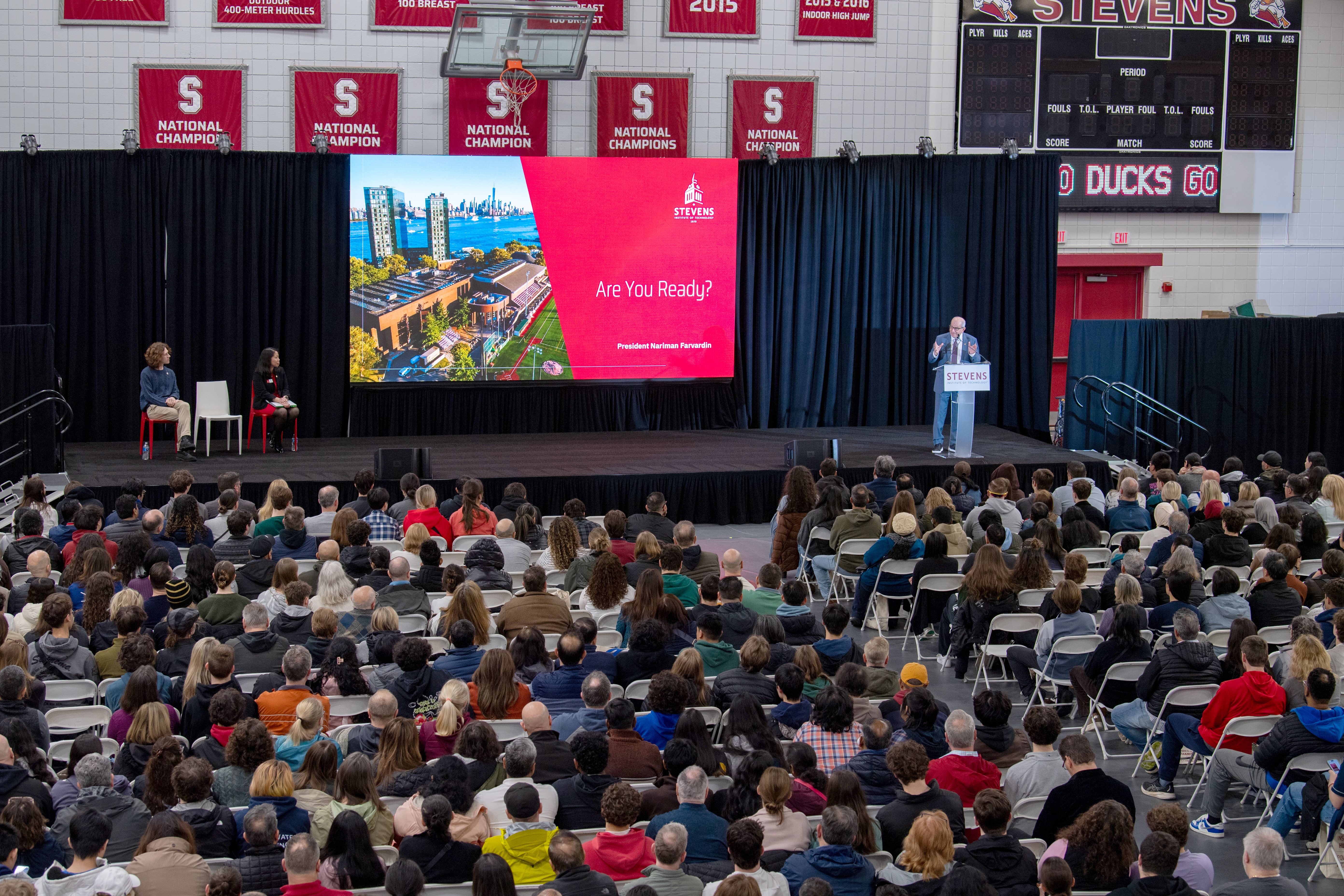 Nariman Farvardin speaks to a crouwd of admitted students in the gym.