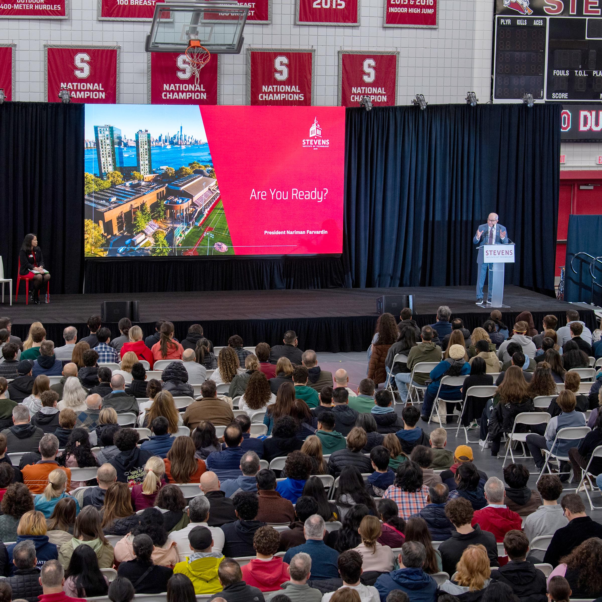 Nariman Farvardin speaks to a crouwd of admitted students in the gym.