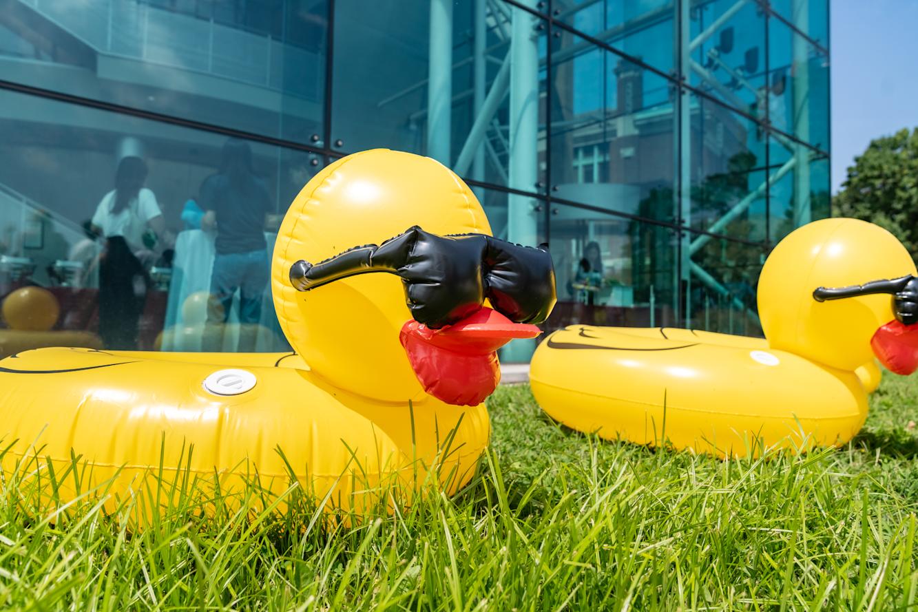 An large inflatable duck wearing sunglasses.