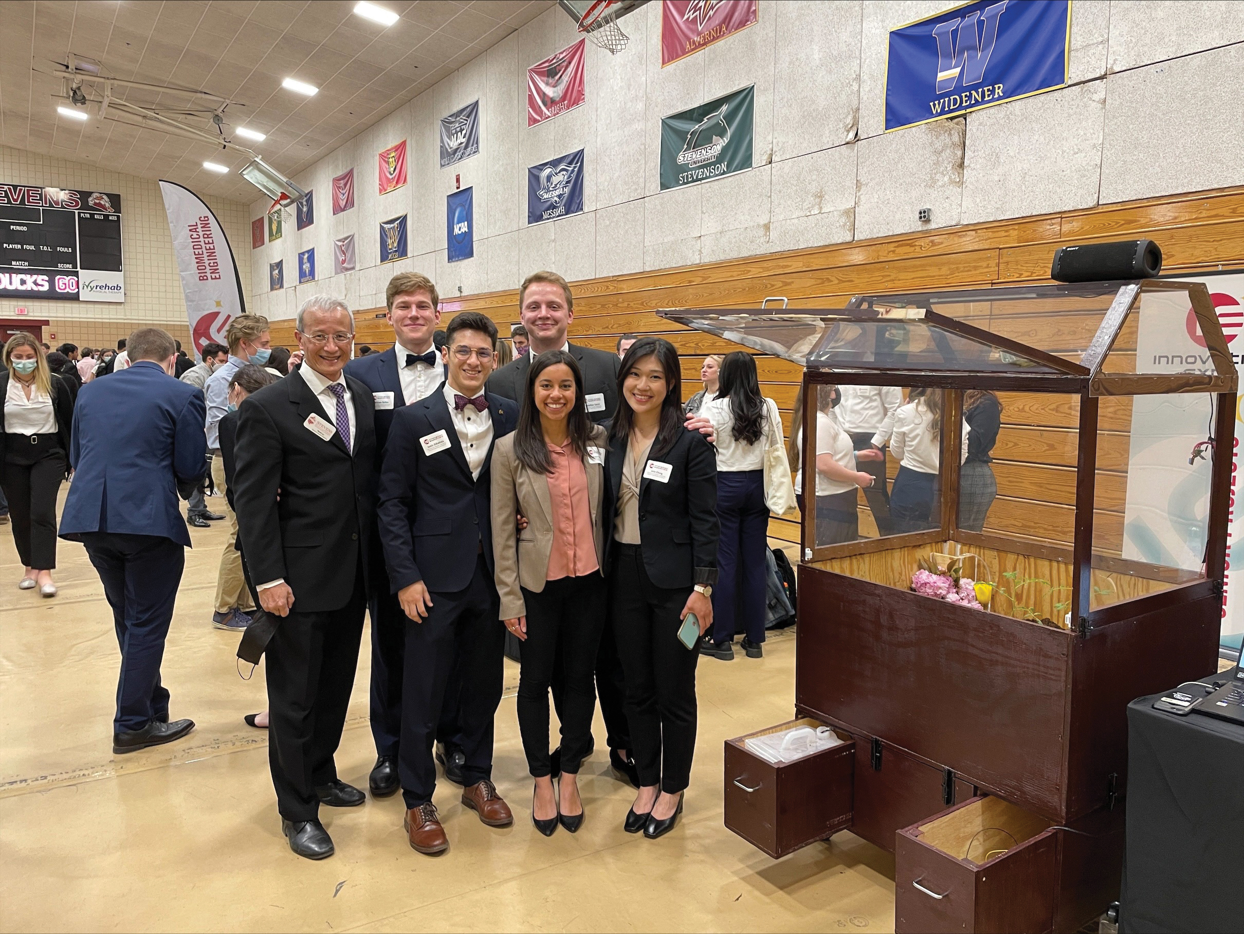 Students at Innovation Expo next to their presentation.