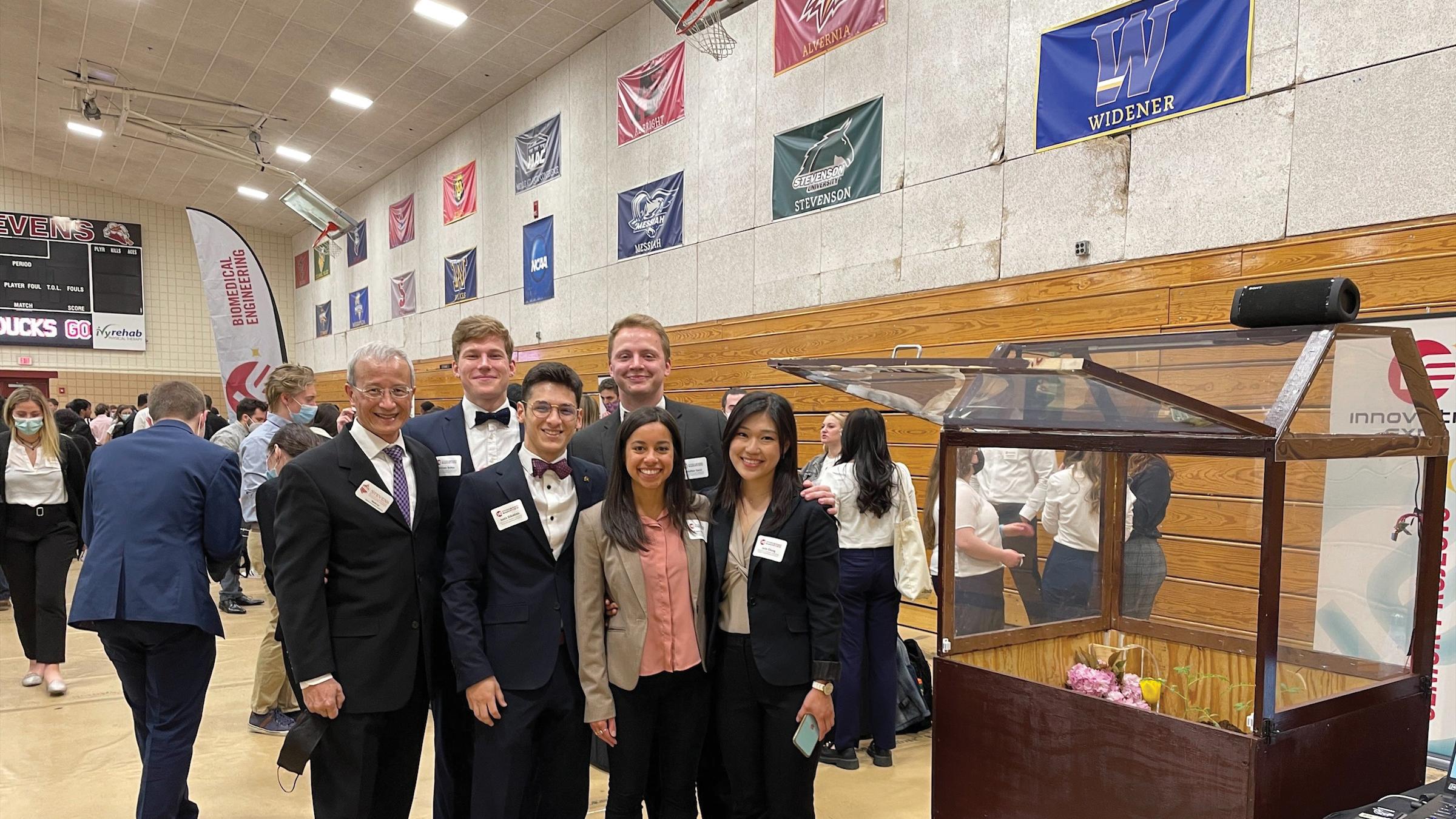 Students at Innovation Expo next to their presentation.