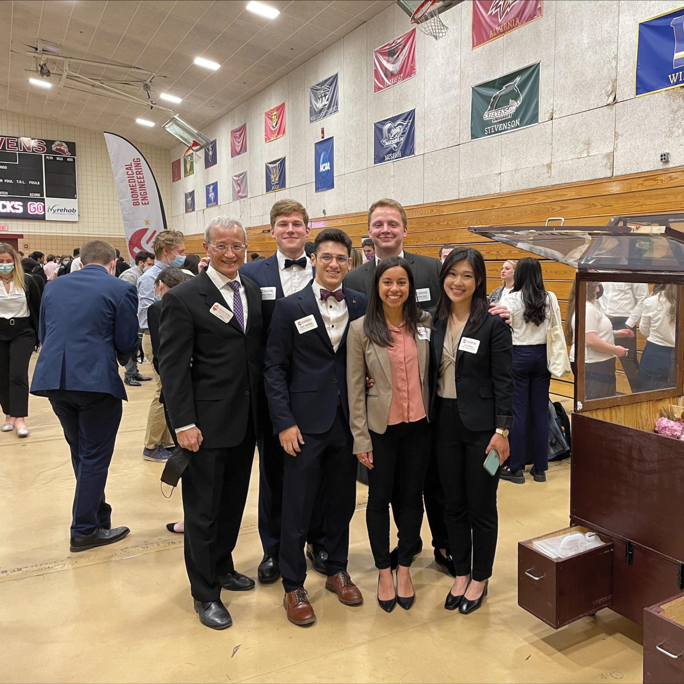 Students at Innovation Expo next to their presentation.
