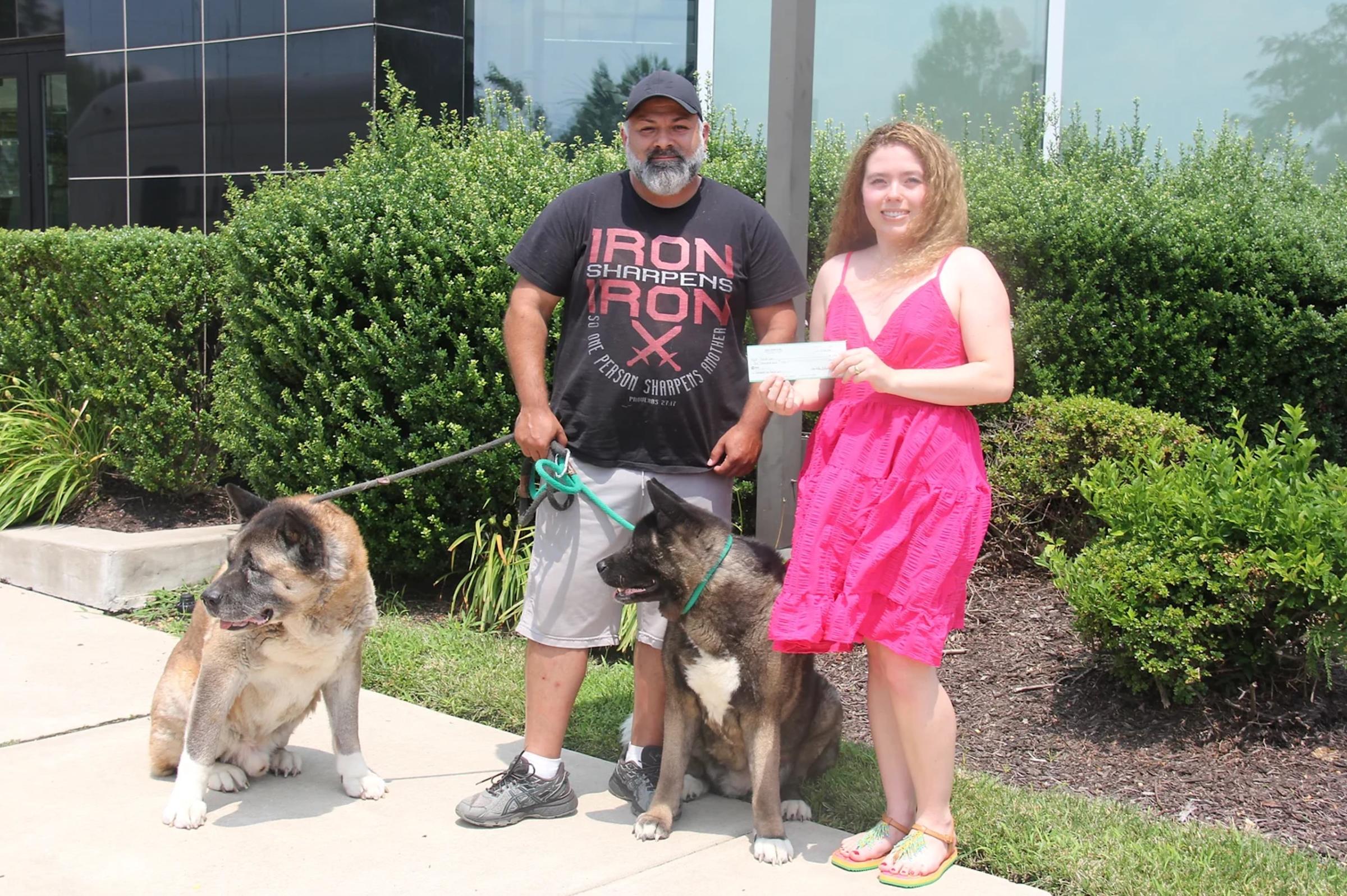 Isabella Valeninto presents a check to Daniel 