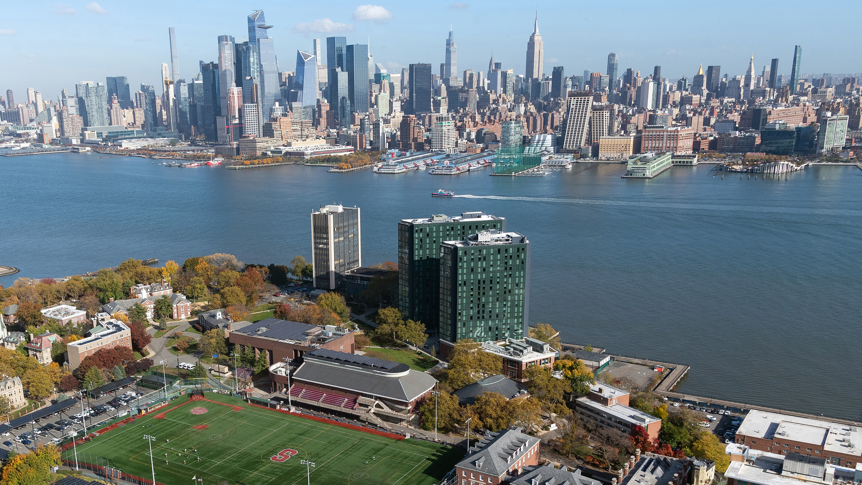 Aerial photograph of Stevens campus with Mahattan skyline in background.