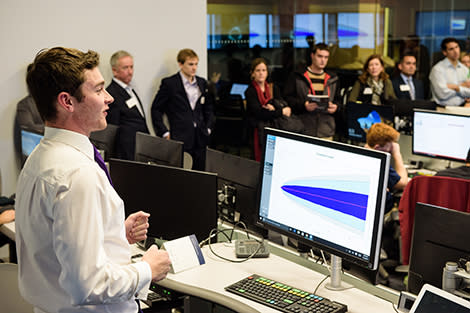 A student demonstrates the results of a data analysis project