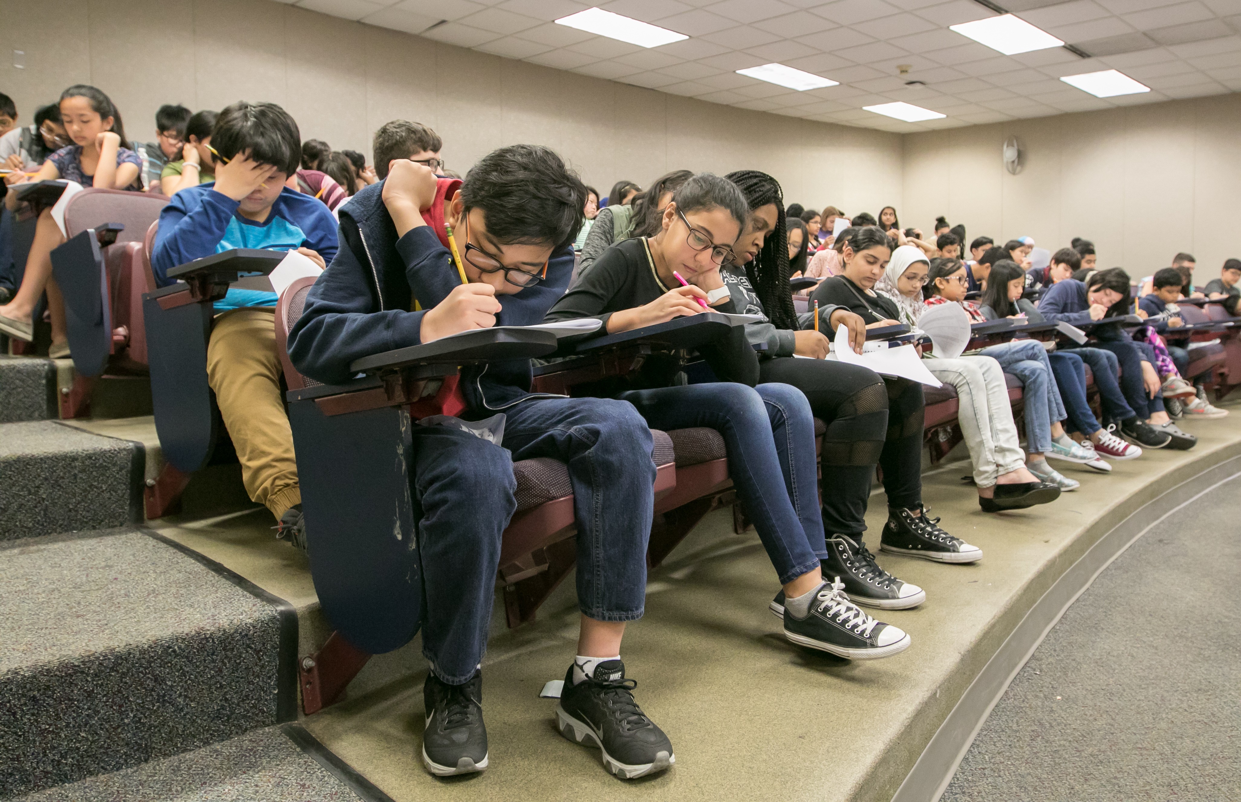 Students in a lecture hall doing math