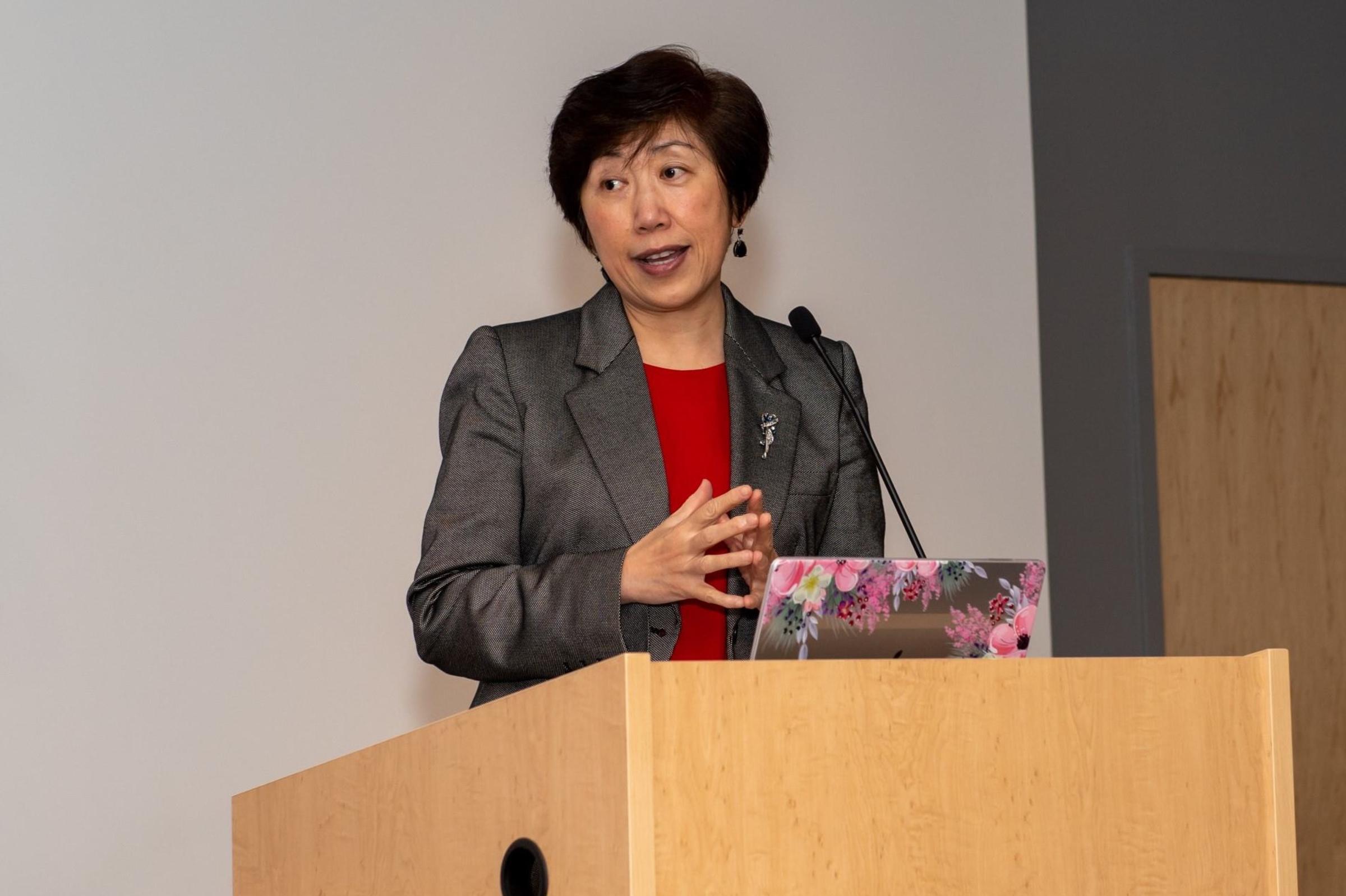 Dean Jean Zu stands behind a podium as she presents awards at the 2022 SES Faculty Awards