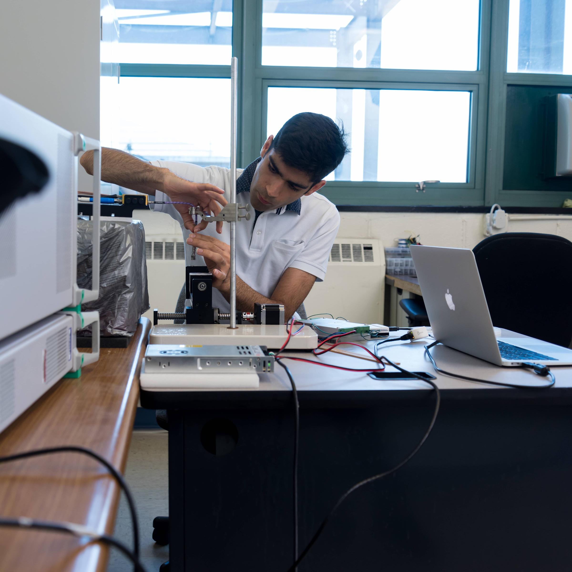 Photo of Amir Mirbeik working in the lab