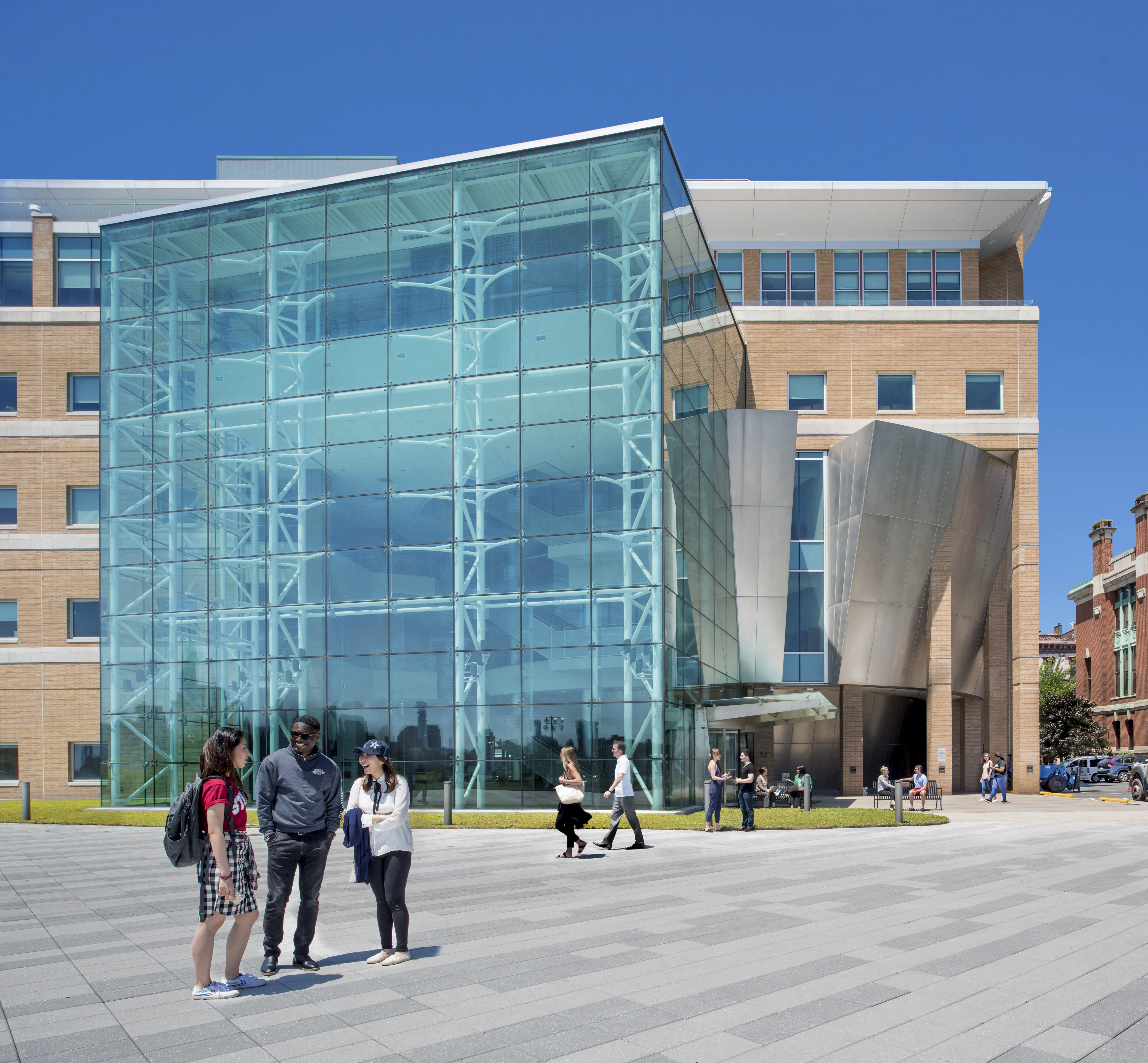 Plaza outside Babbio Center on a sunny day with students socializing.