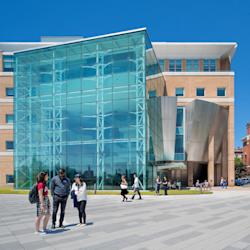 Plaza outside Babbio Center on a sunny day with students socializing.