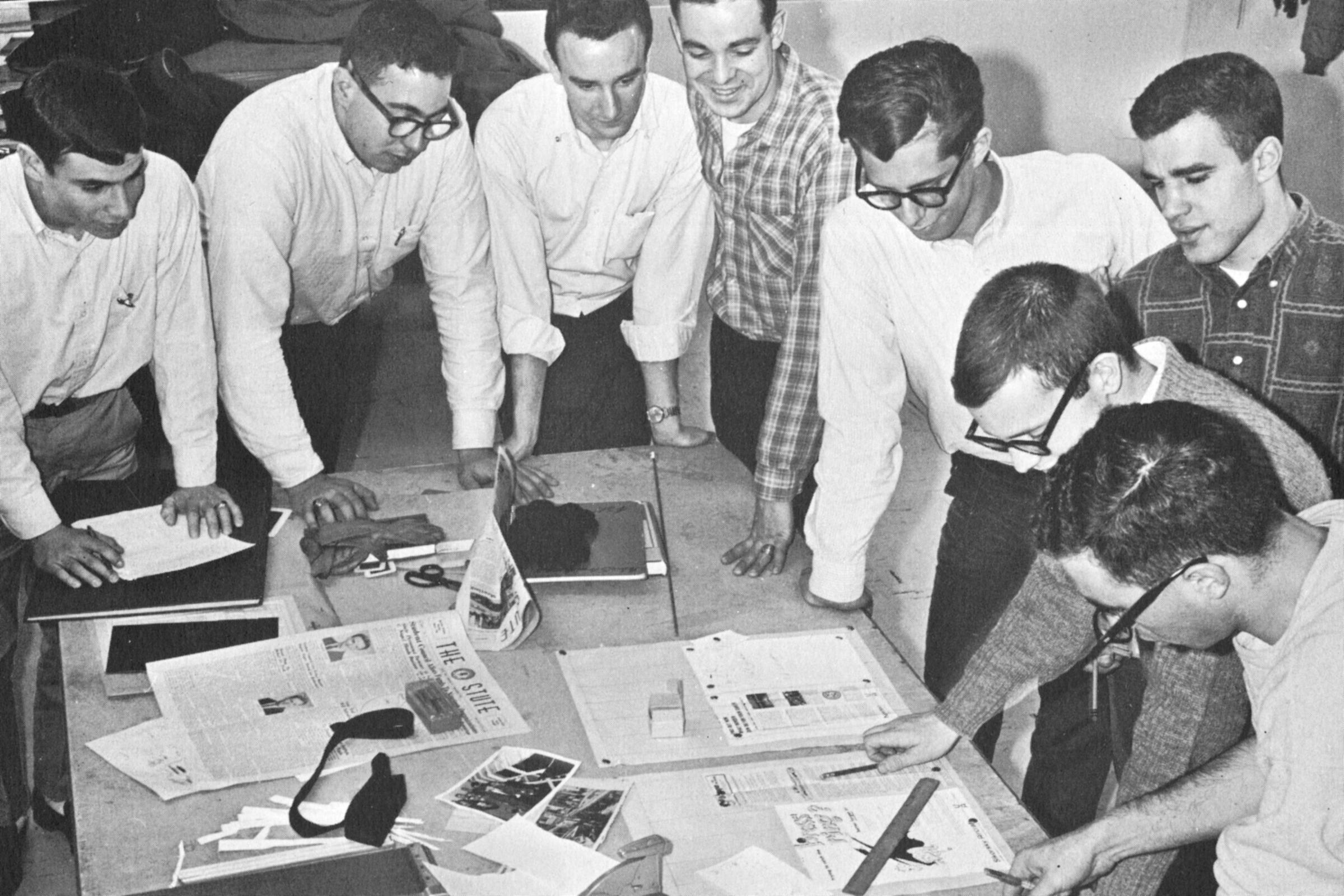 A group of editors around a layout table.