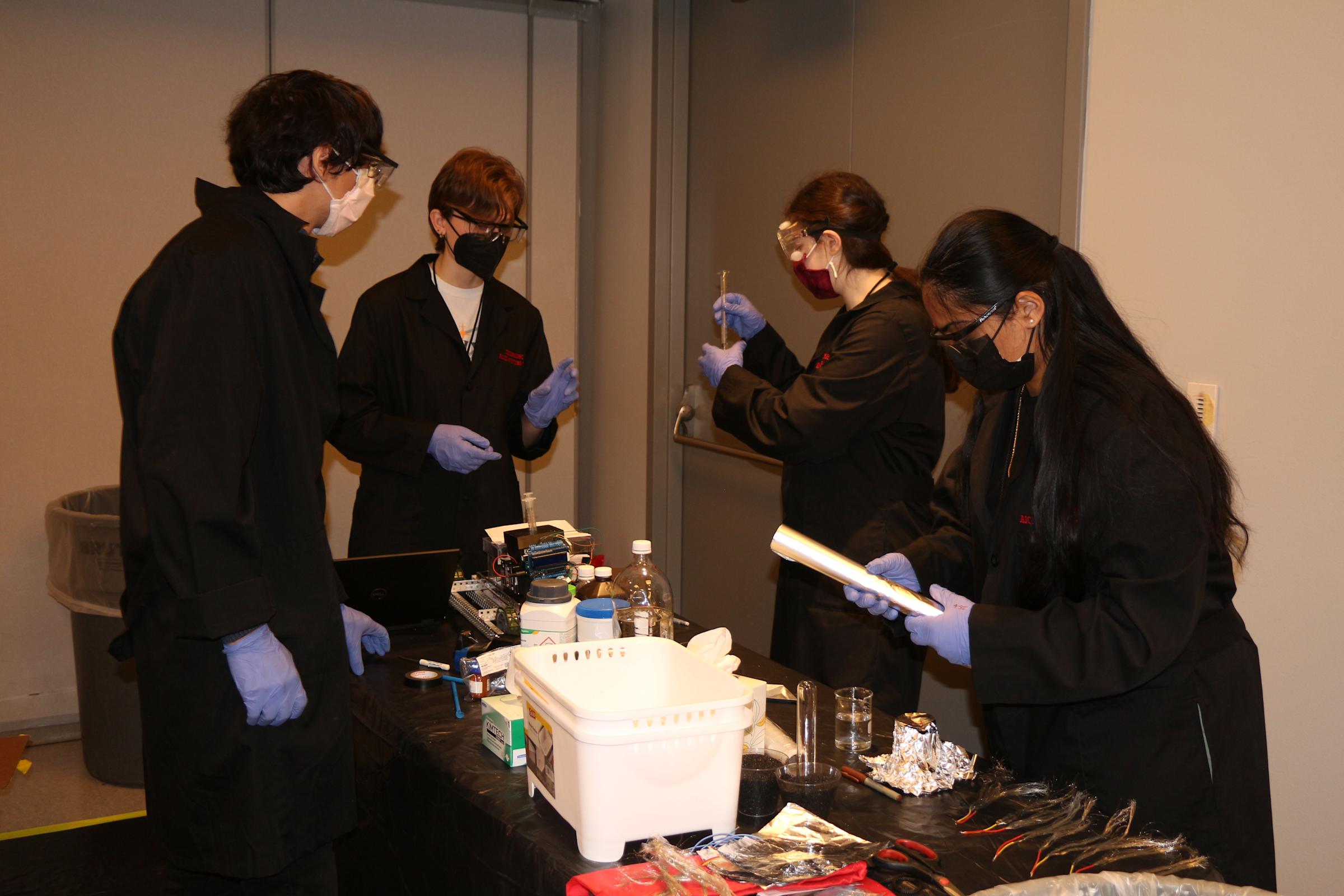 Angel Burgos in the Battery laboratory working with other students on a research project