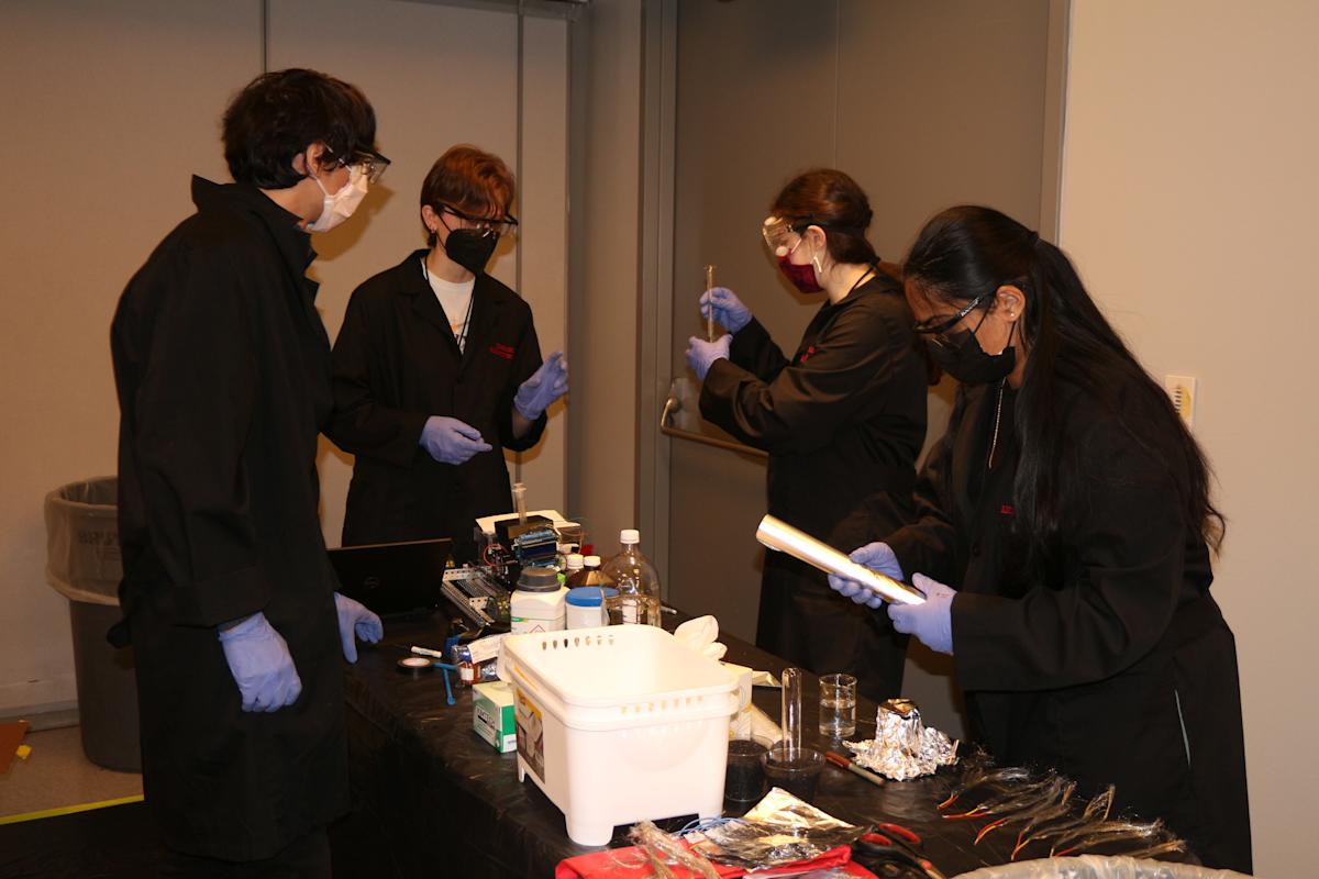 Angel Burgos in the Battery laboratory working with other students on a research project