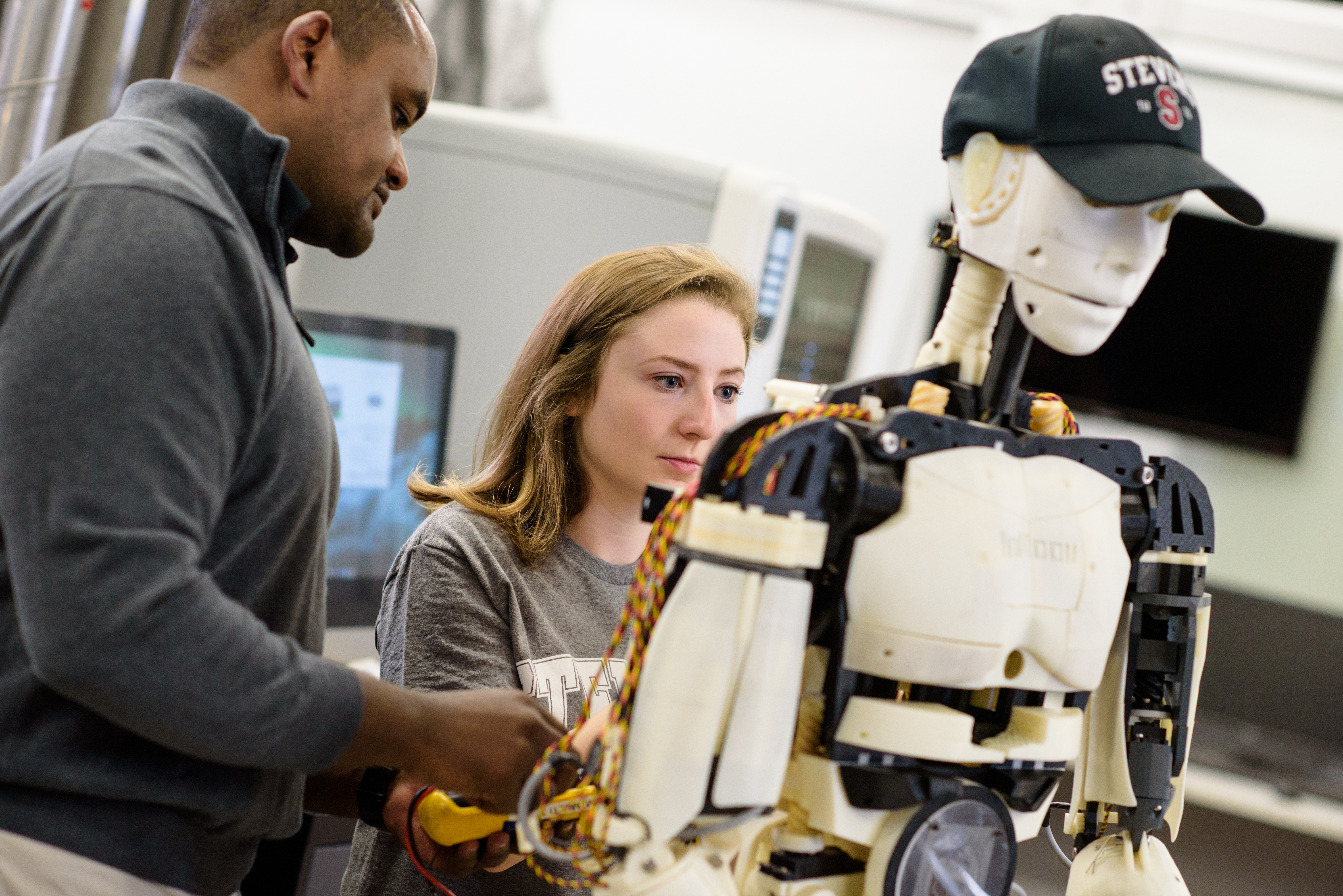 Faculty and students working in a lab on a robot.