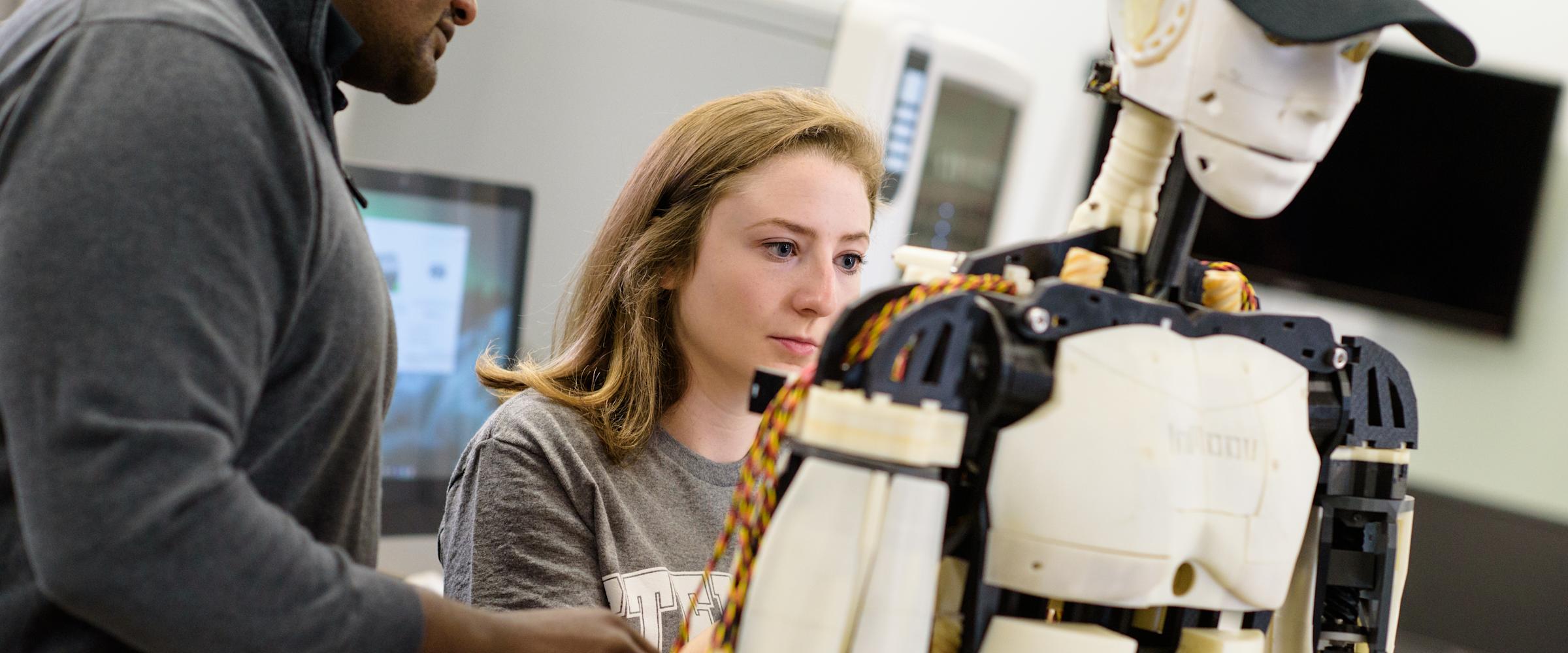 Faculty and students working in a lab on a robot.