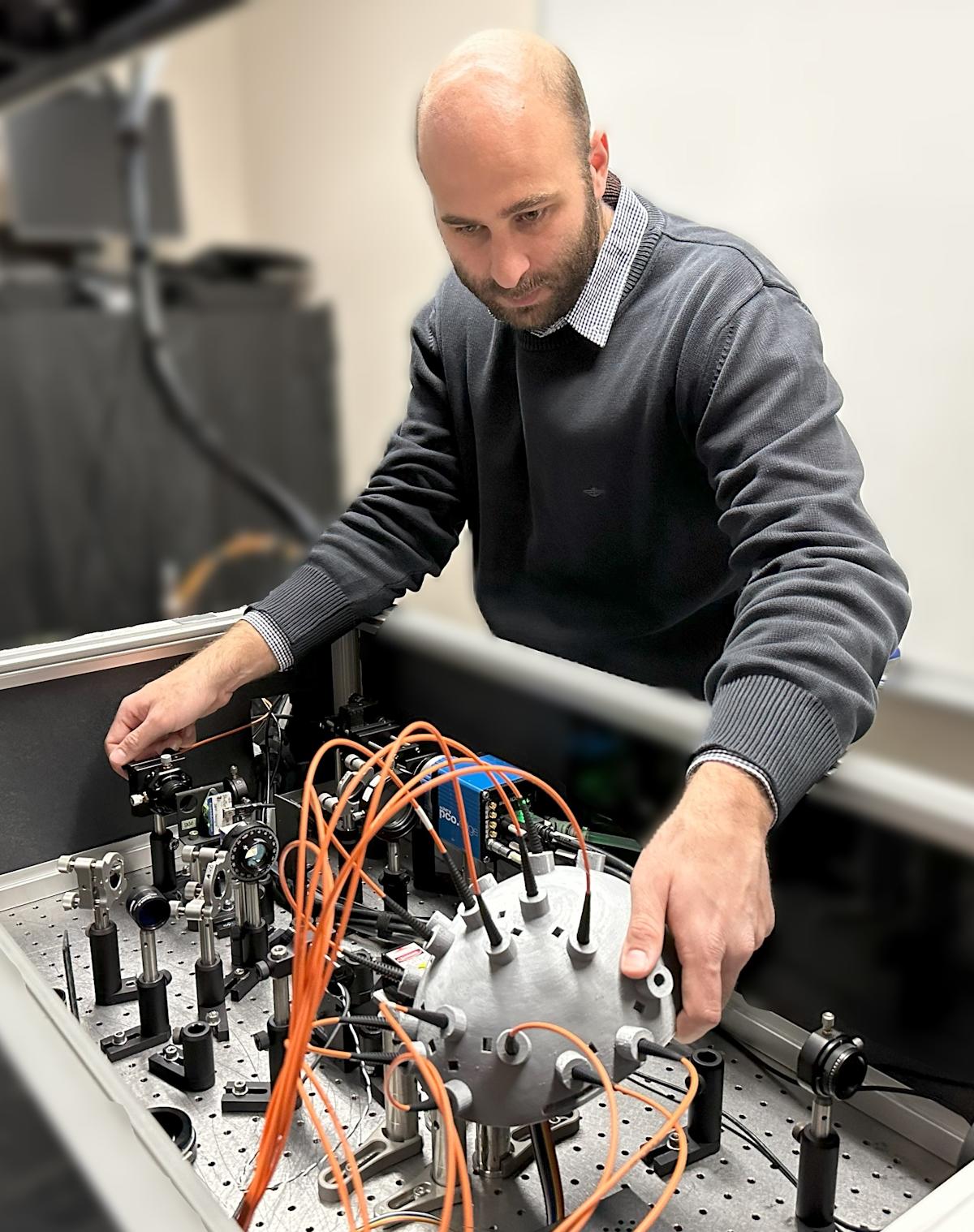 Simon Mahler working with lab equipment.